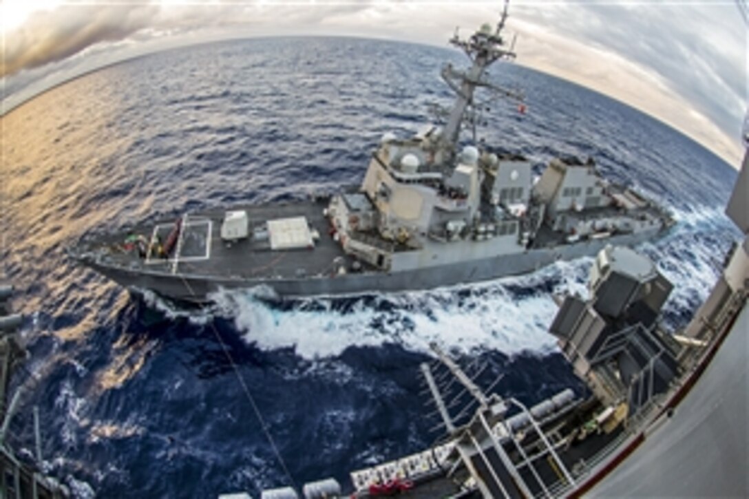 The guided-missile destroyer USS Chafee pulls next to the aircraft carrier USS George Washington to prepare for a refueling operation in the Coral Sea, June 26, 2015.