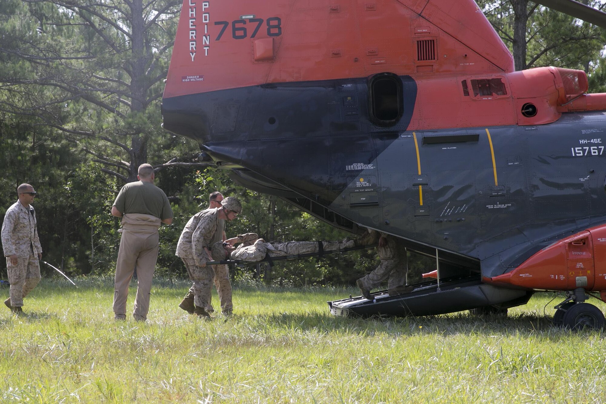 Sailors with 2nd Medical Battalion, 2nd Marine Logistics Group, practice loading patients into an HH-46E Sea Knight with Marine Transport Squadron 1, Marine Corps Air Station Cherry Point, June 23, 2015, aboard Camp Lejeune, N.C., as part of a medical field exercise. The medical exercise is being conducted in order to familiarize the medical personnel with their capabilities and equipment in an austere environment. (U.S. Marine Corps photo by Cpl. Elizabeth Case/Released)
