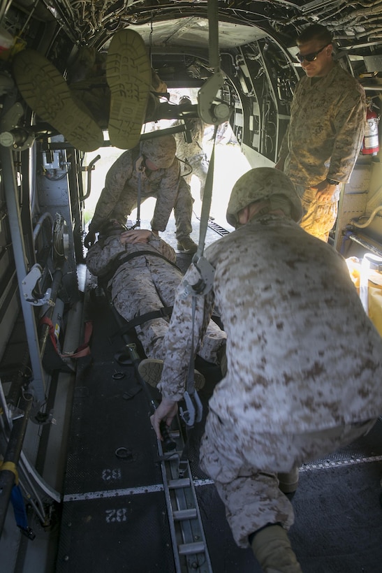 Sailors with 2nd Medical Battalion, 2nd Marine Logistics Group, practice securing a litter for medical evacuations on a HH-46E Sea Knight aircraft, June 23, 2015, aboard Camp Lejeune, N.C., as part of a medical field exercise. The medical exercise is being conducted in order to familiarize the medical personnel with their capabilities and equipment in an austere environment). The HH-46E is with Marine Transport Squadron 1, Marine Corps Air Station Cherry Point. (U.S. Marine Corps photo by Cpl. Elizabeth Case/Released)