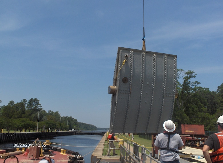 Norfolk District derrick boat Elizabeth lifts a 9,000 pound refurbished lock valve into place on the Great Bridge Lock in Chesapeake, Virginia. 