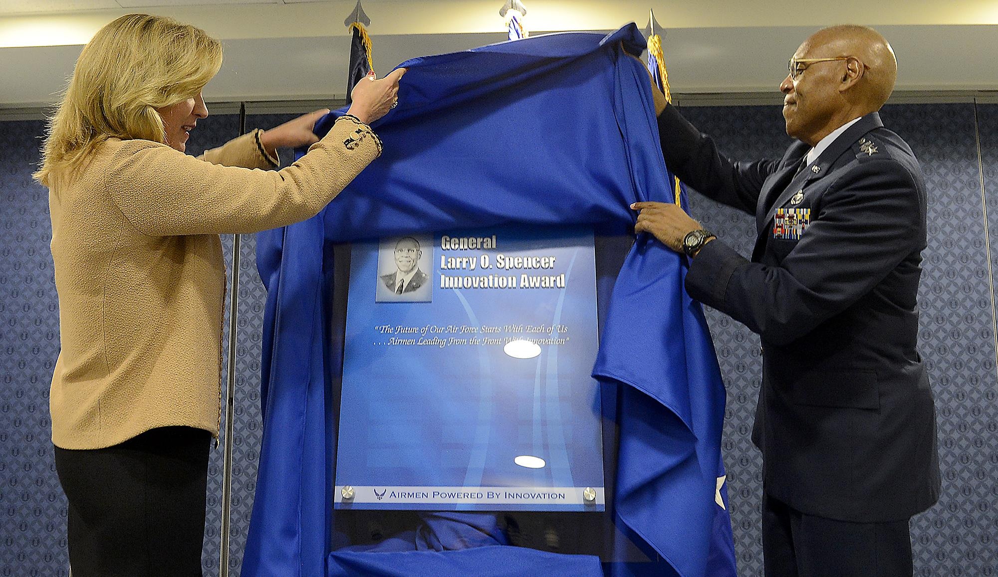 Secretary of the Air Force Deborah Lee James and Air Force Vice Chief of Staff Gen. Larry O. Spencer pull the shroud during the ceremonial unveiling of the Gen. Larry O. Spencer Innovation Award, named in Spencer's honor, June 29, 2015, at the Pentagon. The idea was conceived by Air Force Chief of Staff Gen. Mark A. Welsh III to recognize Airmen who share their creative and efficient ways to save money and time. (U.S. Air Force photo/Scott M. Ash)