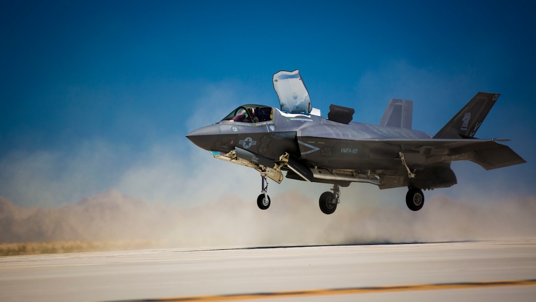 An F-35B Lightning II with Marine Fighter Attack Squadron 121, based out of Marine Corps Air Station Yuma, Ariz., performs a vertical landing as part of required flying field carrier landing practices (FCLP) at the station’s auxiliary landing field, Monday, April 27, 2015. The landing field simulates the flight deck of an aircraft carrier to prepare pilots for landing and taking off at sea. (Official Marine Corps photo by Cpl. Travis Gershaneck/Released)