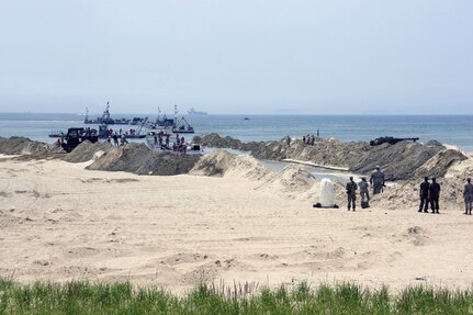 ANMYEON BEACH, Republic of Korea (June 29, 2015) - 331st Transportation Company (Modular Causeway System) inserts a Trident Pier into Anmyeon Beach on the west coast during exercise Combined Joint Logistics Over the Shore (LOTS) 2015.  LOTS are military activities that include offshore loading and unloading of ships when fixed port facilities are unavailable or denied due to enemy activities.  
