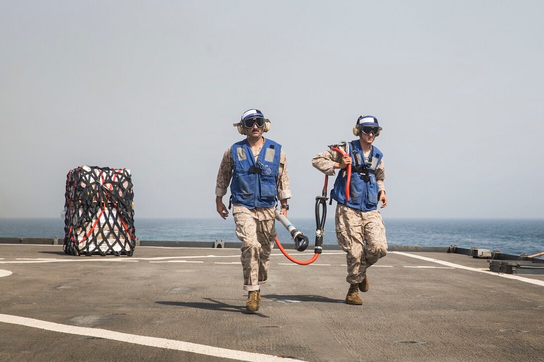 U.S. Marines with the 15th Marine Expeditionary Unit retrieve a cargo hook during a replenishment at sea aboard the Whidbey Island-class dock landing ship USS Rushmore (LSD 47). Marines and sailors with the 15th Marine Expeditionary Unit, and Essex Amphibious Ready Group  worked together to offload food, maintenance parts, and letters from home. The 15th MEU is embarked on the Essex ARG and deployed to maintain regional security in the U.S. 5th Fleet area of operations. (U.S. Marine Corps photo by Sgt. Emmanuel Ramos/Released)