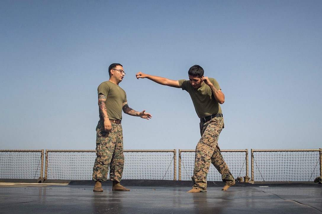 U.S. Marine Gunnery Sgt. Orlando Villalobos, left, and Gunnery Sgt. Jesus Cuellar demonstrate how to counter a punch during a Marine Corps Martial Arts Program course aboard the USS Rushmore (LSD 47). Villalobos is a logistics chief with Combat Logistics Battalion 15, 15th Marine Expeditionary Unit and Cuellar is the information assurance manager with the 15th MEU’s Command Element. MCMAP trains Marines on hand-to-hand combat skills essential to mission readiness, and is a good source of physical fitness while deployed. The 15th MEU is embarked on the Essex Amphibious Ready Group and deployed to maintain regional security in the U.S. 5th Fleet area of operations. (U.S. Marine Corps photo by Sgt. Emmanuel Ramos/Released)