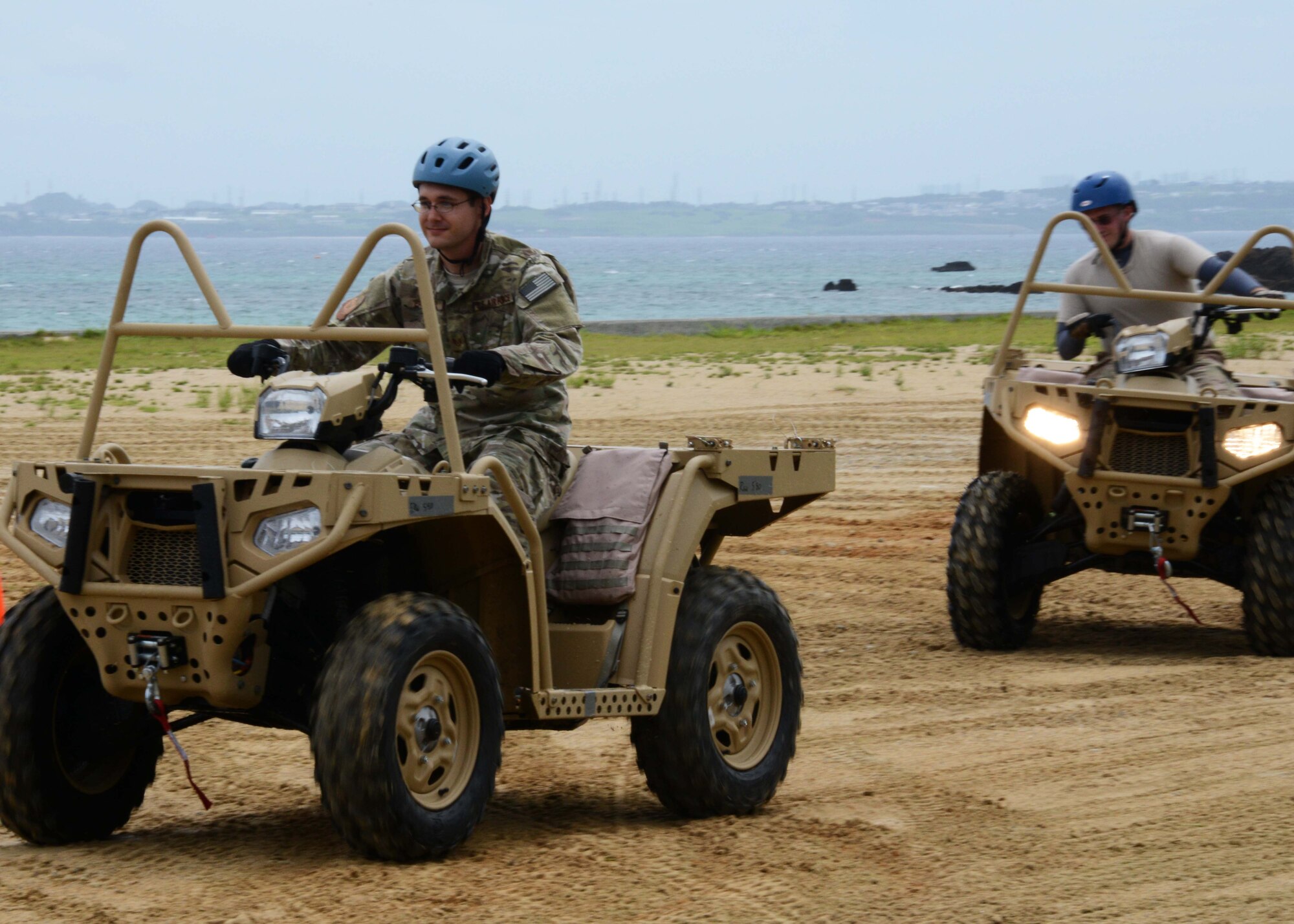 Two Gold Team members from the 320th Special Tactics Squadron Gold Flight, receive all-terrain vehicle qualification training during exercise Gold Thunder 2.0 at Camp Hansen, Japan, June 23, 2015.  It is necessary for members to be able to cover more ground on the quad when securing the area.  Gold Thunder 2.0 is a humanitarian assistance/disaster relief scenario exercise put together to train the combat mission support personnel in land and water navigation, establishing a special tactics operations center and a forward operating logistics hub along with other skills such as all-terrain vehicle qualification training, Krav Maga training and exfiltration capabilities with rotary wing aircraft. (U.S. Air Force photo by Tech. Sgt. Kristine Dreyer)  (U.S. Air Force photo by Tech. Sgt. Kristine Dreyer, 353rd SOG PA/Released)