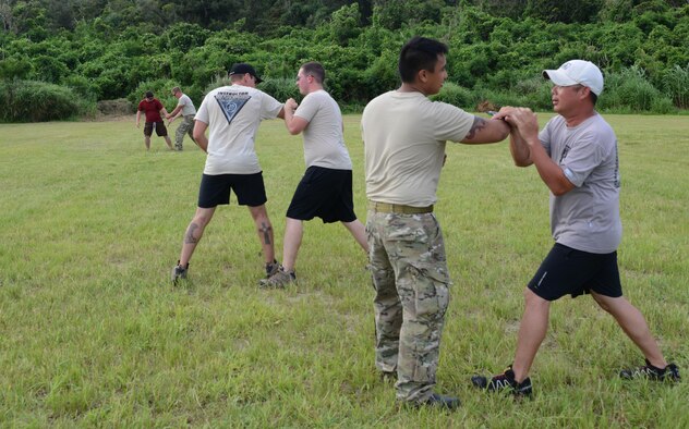 Members from 320th Special Tactics Squadron Gold Team, receive Krav Maga training during exercise Gold Thunder 2.0 at Camp Hansen, Japan, June 23, 2015.  Gold Thunder 2.0 is a humanitarian assistance disaster relief scenario exercise put together to train the combat mission support personnel in land and water navigation, establishing a special tactics operations center and a forward operating logistics hub along with other skills such as all-terrain vehicle qualification training, Krav Maga training and exfiltration capabilities with rotary wing aircraft. (U.S. Air Force photo by Tech. Sgt. Kristine Dreyer)