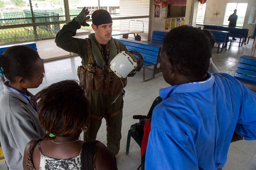 U.S. Navy Petty Officer 3rd Class Chris Johnson gives a passenger safety brief to members of the media from Papua New Guinea during Pacific Partnership 2015, June 27, 2015. Johnson is an naval aircrewman assigned to Helicopter Sea Combat Squadron 21.