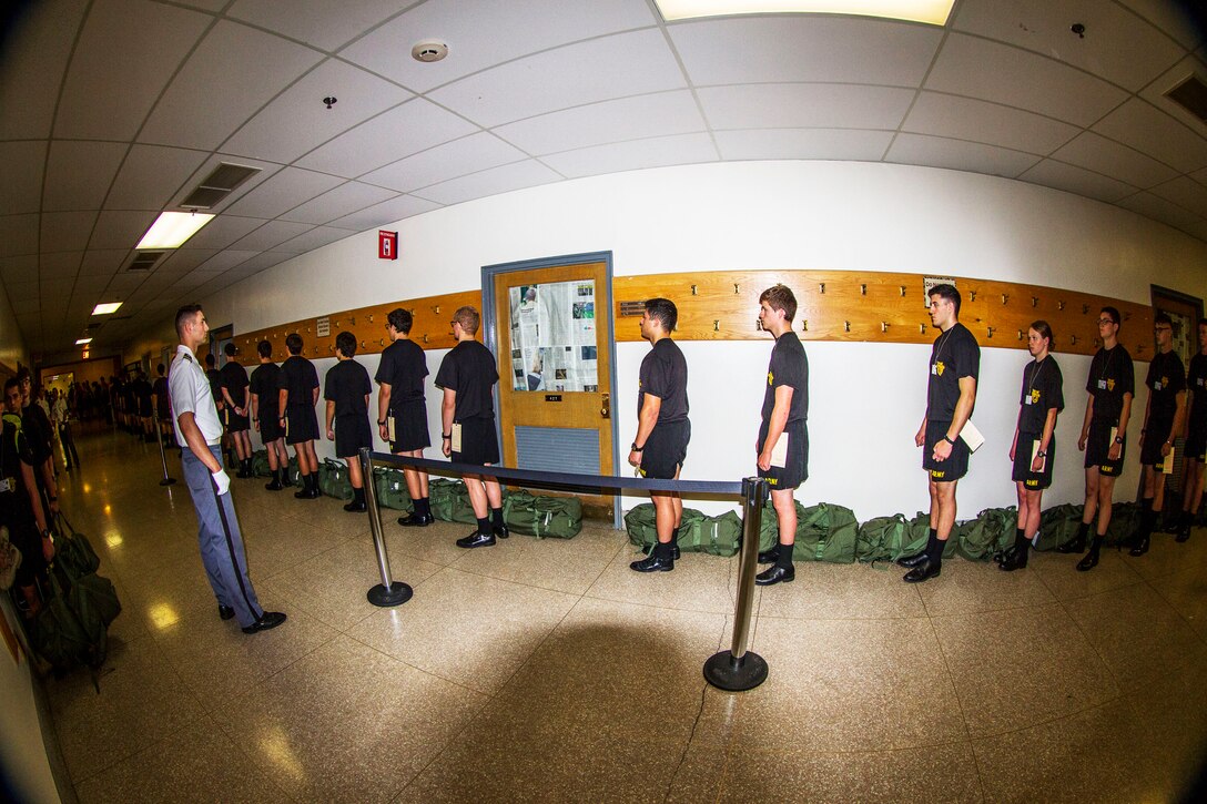 Future cadets reporting to the United States Military Academy at West Point are lined up for processing under the watchful eye of a Cow, or cadet in his third year at the Academy, at Thayer Hall on R-day. Almost 1,300 future cadets reported on R-day this year which is typically held on the last Monday of every June. (