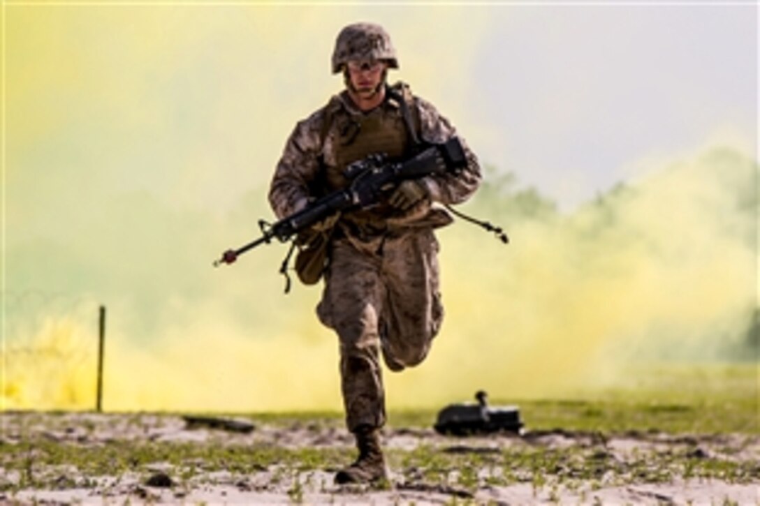 Marine Corps Lance Cpl. Alex Rowan runs for cover before a breaching system detonates during a sapper leader's course on Marine Corps Base Camp Lejeune, N.C., June 26, 2015. Rowan is a combat engineer assigned to the 4th Combat Engineer Battalion.