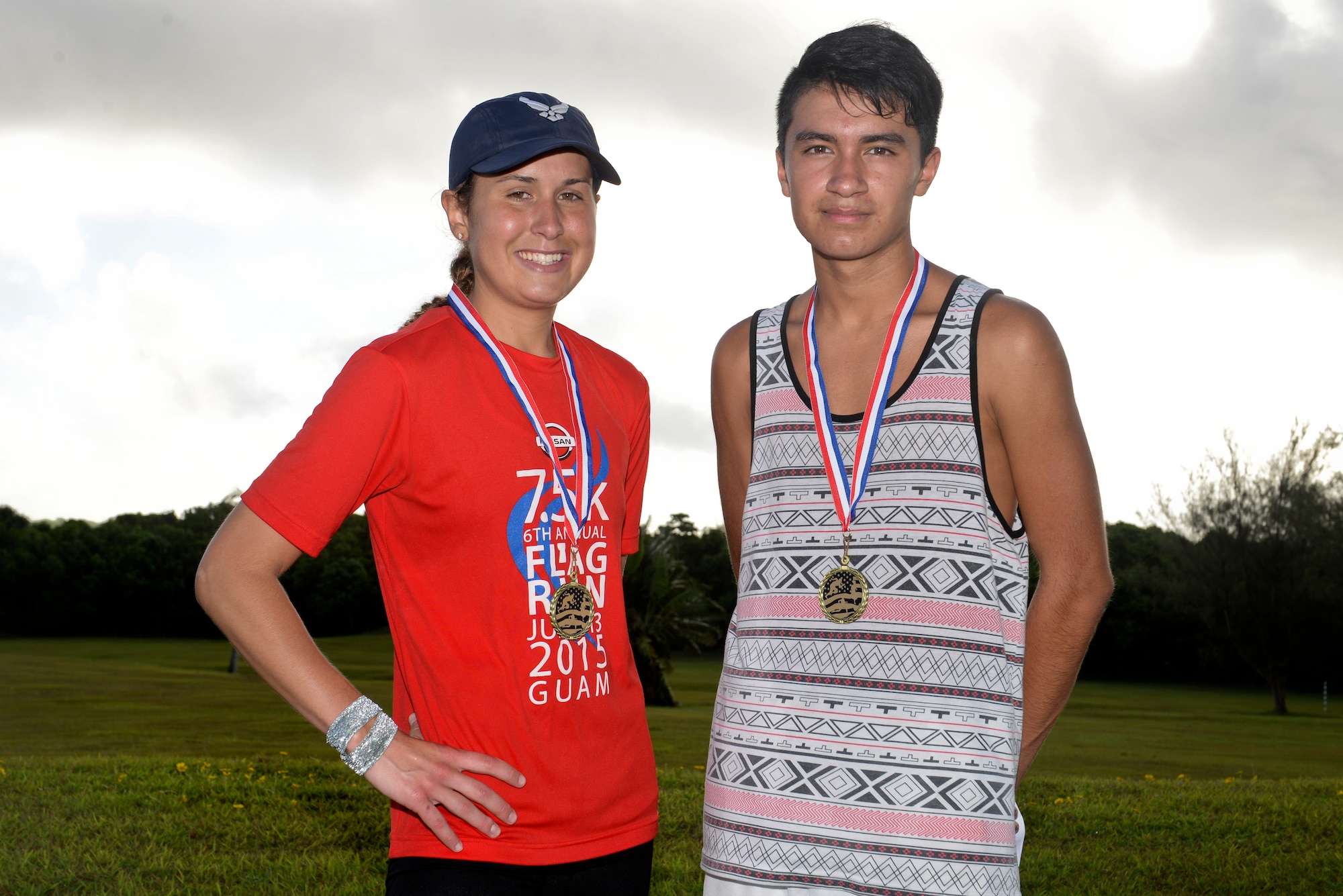 Meara McCarthy and Isaec Ventura, race participants, stand together after the Red, White and Blue 5K July 1, 2015, at Andersen Air Force Base, Guam. McCarthy took first place for the females with a time of 20 minutes, 41 seconds and Ventura took first place for the males with a time of 19 minutes, 3 seconds. (U.S. Air Force photo by Senior Airman Katrina M. Brisbin/Released)