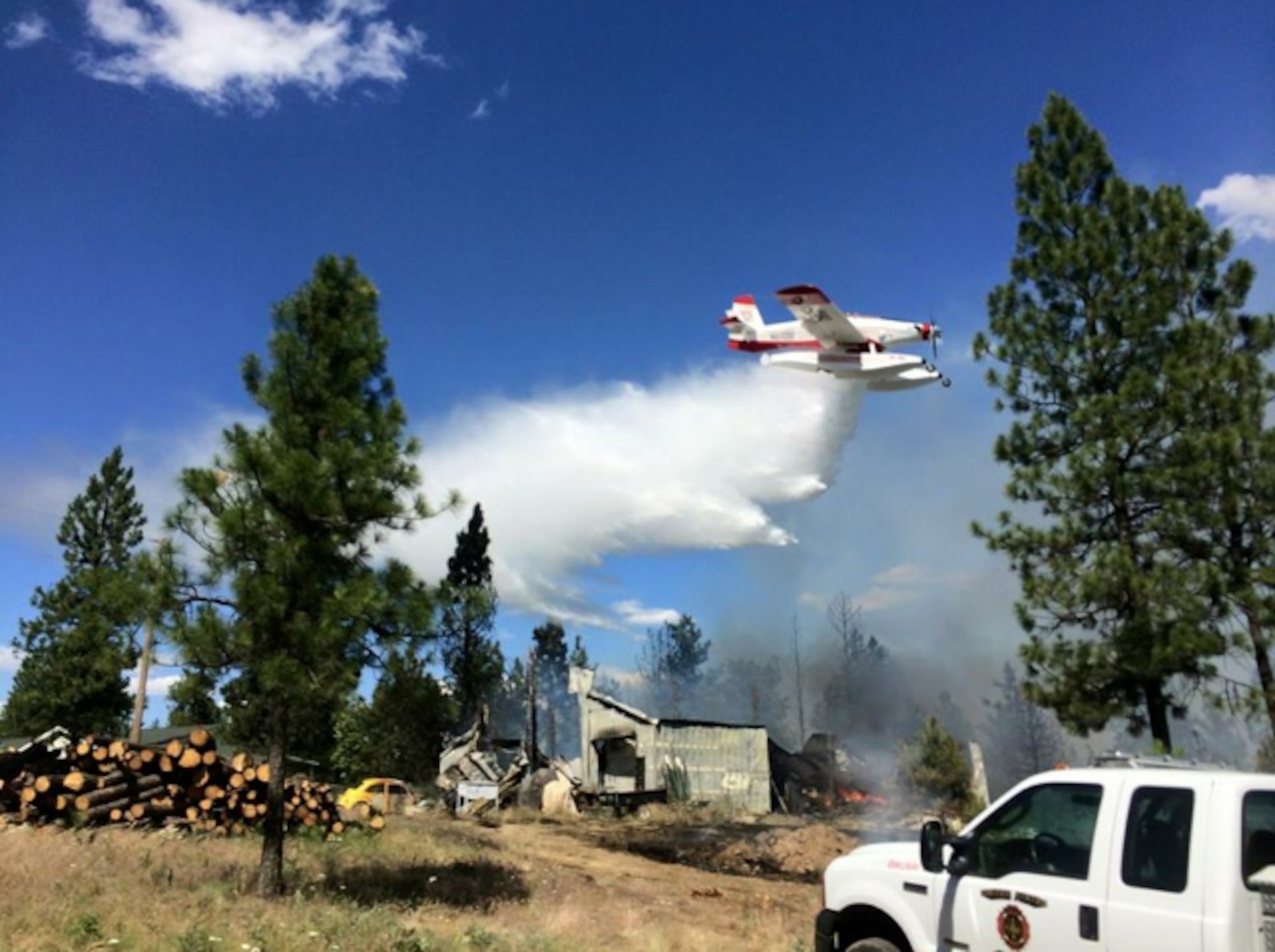 Firefighters from Fairchild Air Force Base, Wash., assisted other area firefighters saving homes and their inhabitants from the Fish Lake Fire near Cheney, Wash., June 17, 2015. The 145-acre brush fire began June 17 and was contained by midnight June 18. Fires like these can be started by something as simple as a cigarette or glass bottle, especially during draught conditions like those Washington state is currently experiencing. (U.S. Air Force photo)