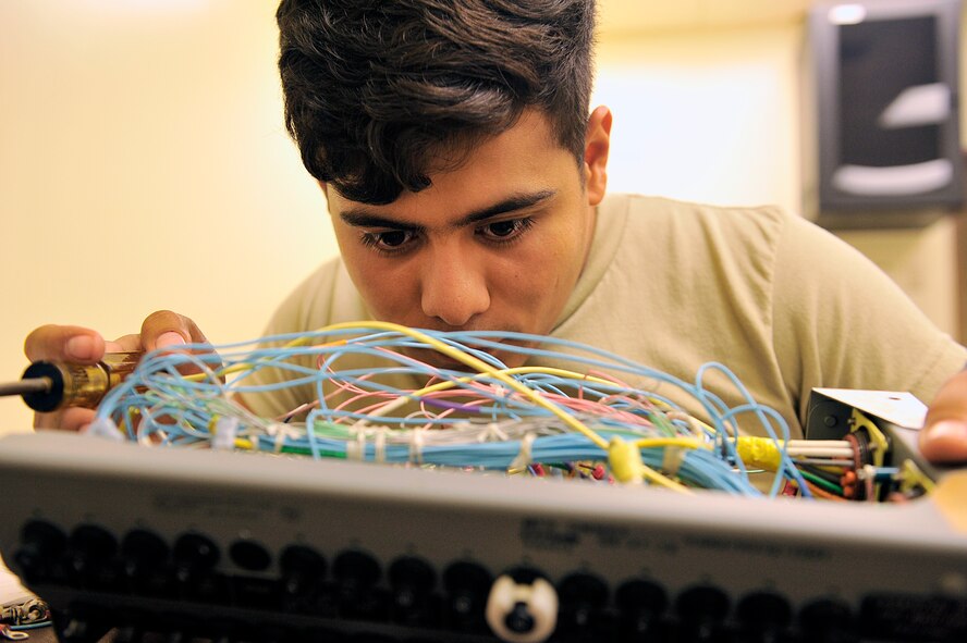 U.S. Air Force Airman 1st Class Victor Lopez Juarez, 18th Component Maintenance Squadron electrical and environmental journeyman, reviews inside of an F-15C Eagle essential bus circuit breaker panel on Kadena Air Base, Japan, June 29, 2015. Airmen from 18th CMS have been working around-the-clock to rewire F-15C Eagle essential bus circuit breaker panels to help increase mission capabilities and to ensure unmatched combat power of Kadena's aircraft. (U.S. Air Force photo by Naoto Anazawa)

