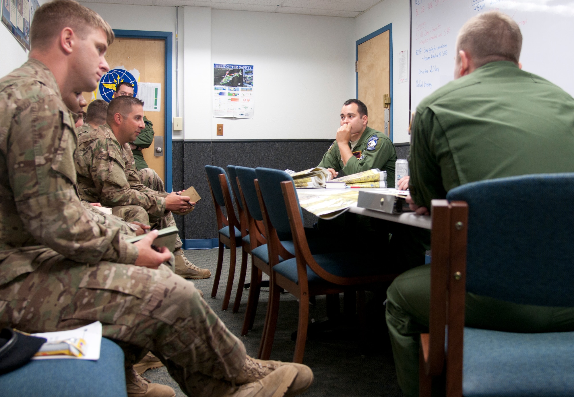 Capt. Michael Carter, 582nd Helicopter Group flight safety officer, and his flight crew, talk with a 790th Security Forces Squadron tactical response force team June 12, 2015, at the 37th Helicopter Squadron building prior to their flight. The 37th Helicopter Squadron provides transportation and support to security forces Airmen that are called to action if an asset was in danger. (U.S. Air Force photo by Airman 1st Class Malcolm Mayfield)