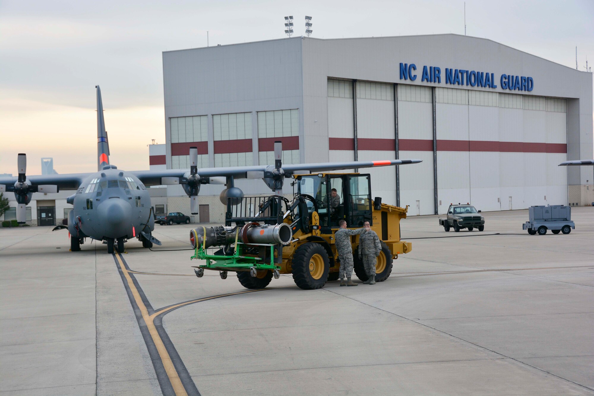 North Carolina Air National Guard aerial porters, use an all-terrain forklift to carry a nozzle of a Modular Airborne Firefighting System II (MAFFS II) to waiting 145th Airlift Wing, C-130 Hercules aircraft at the North Carolina Air National Guard Base, Charlotte Douglas International Airport; April 29, 2015, in preparation for the 2015 MAFFS annual training being held in Greenville, S.C. MAFFS II discharges the fire retardant through the special nozzle installed and sealed in the modified paratrooper door on the left side of the aircraft. This allows the aircraft to remain pressurized during drop sequences. (U.S. Air National Guard photo by Master Sgt. Patricia F. Moran, 145th Public Affairs/Released)