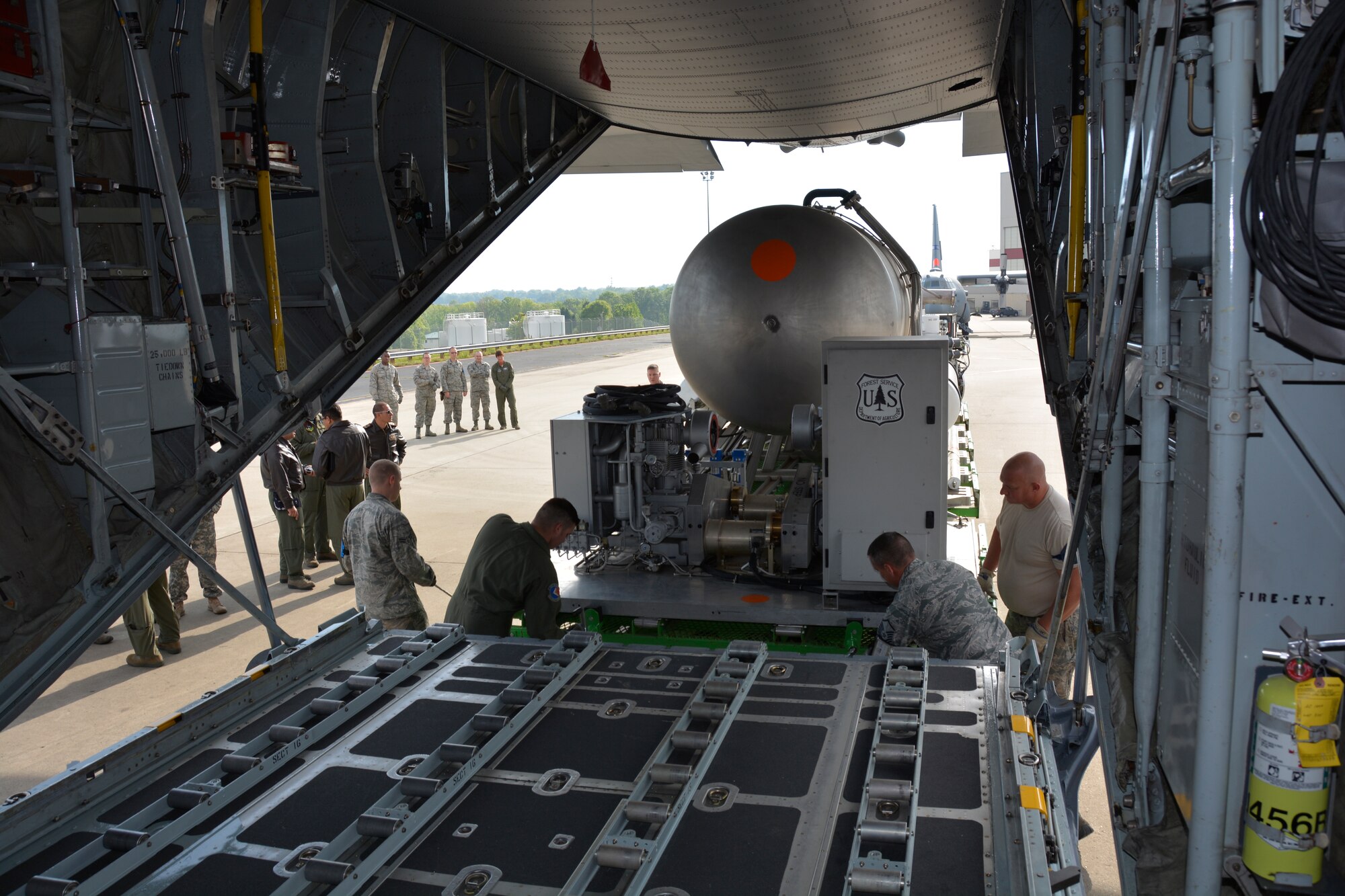 Senior aircrew instructors from the 81st, Escuadrón de Transporte, Bogota, Colombian Fuerza Aerea, were given a first-hand look at a Modular Airborne Firefighting System II (MAFFS II) being loaded into the cargo area of a C-130 Hercules aircraft by 145th Airlift Wing, aerial porters and maintainers at the North Carolina Air National Guard Base, Charlotte Douglas International Airport; April 29, 2015. The Colombians were visiting the NCANG during MAFFS 2015 annual training to gain insight on how aerial firefighting is planned, prepared for and executed. (U.S. Air National Guard photo by Master Sgt. Patricia F. Moran, 145th Public Affairs/Released)