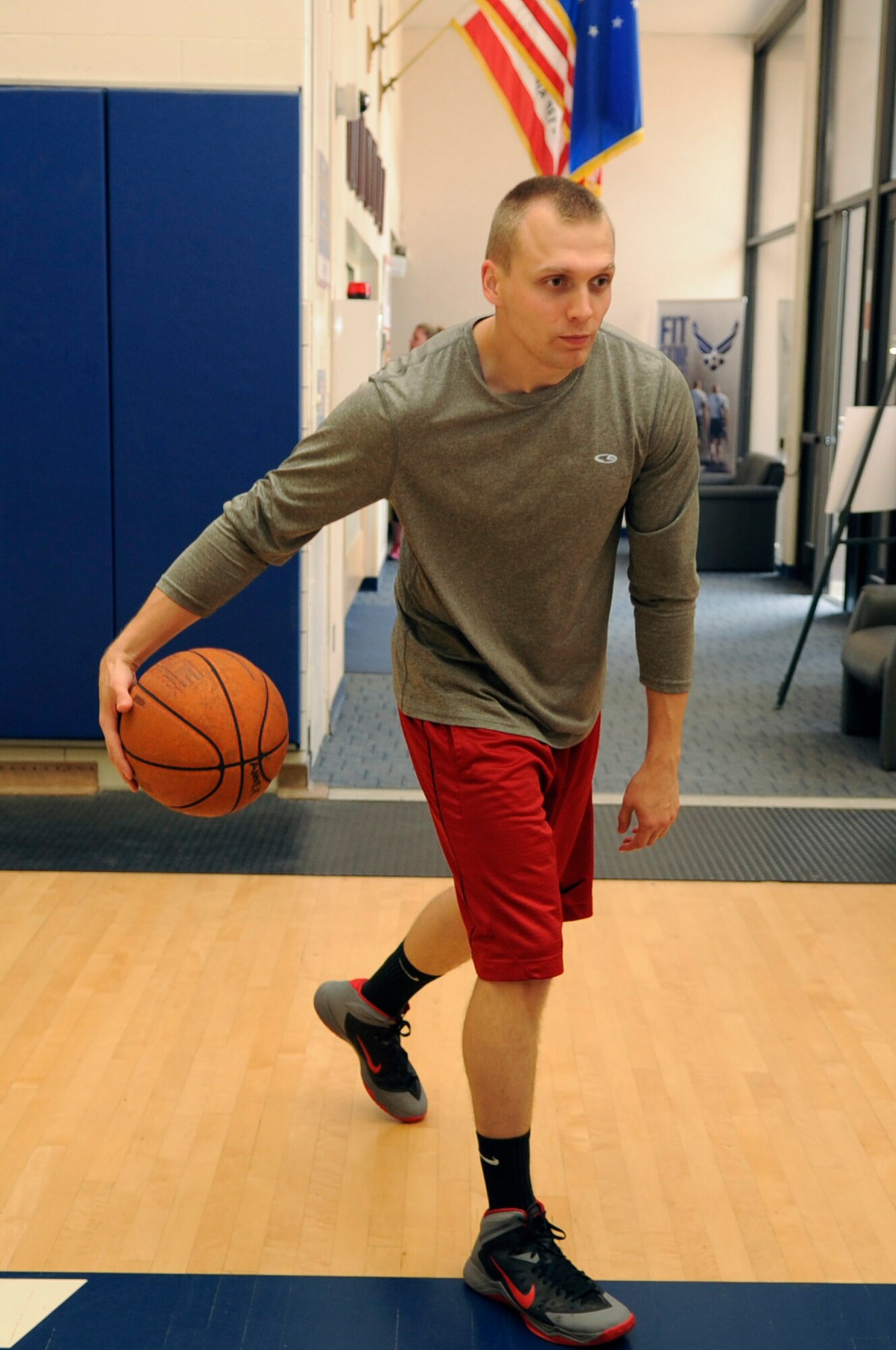 Senior Airman Tyler Cerney, 544th Intelligence, Surveillance and Reconnaissance Group, detachment 1, intelligence analyst, dribbles a basketball, June 29, 2015, Vandenberg Air Force Base, Calif. Through his devotion to bettering the lives of those around him, Cerney has fostered a great deal of pride and respect from his leaders. (U.S. Air Force photo by Senior Airman Shane Phipps/Released)