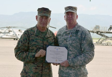 Gen. John Kelly, U.S. Southern Command commander, and Col. Kirk Dorr, Joint Task Force – Bravo outgoing commander, pose for a photo following an award presentation for Dorr June 30, 2015, at Soto Cano Air Base, Honduras. Dorr received the Defense Superior Service Medal for his year in command, prior to the JTF – Bravo change of command ceremony. (U.S. Air Force photo by Martin Chahin)