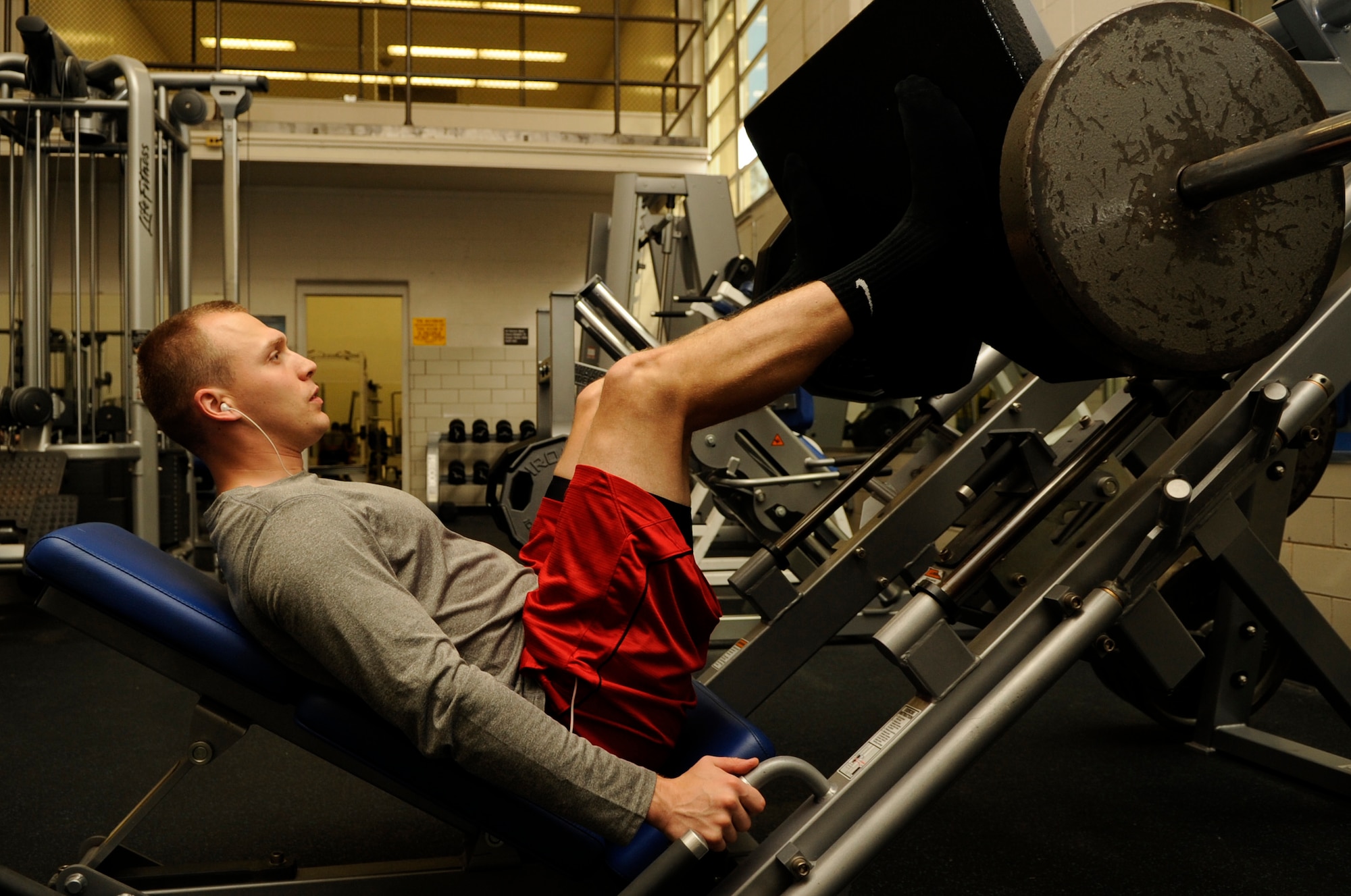 Senior Airman Tyler Cerney, 544th Intelligence, Surveillance and Reconnaissance Group, detachment 1, intelligence analyst, performs a leg press exercise, June 29, 2015, Vandenberg Air Force Base, Calif. For Cerney, the benefits of staying in peak physical condition, especially while in the military, are abundant. (U.S. Air Force photo by Senior Airman Shane Phipps/Released)