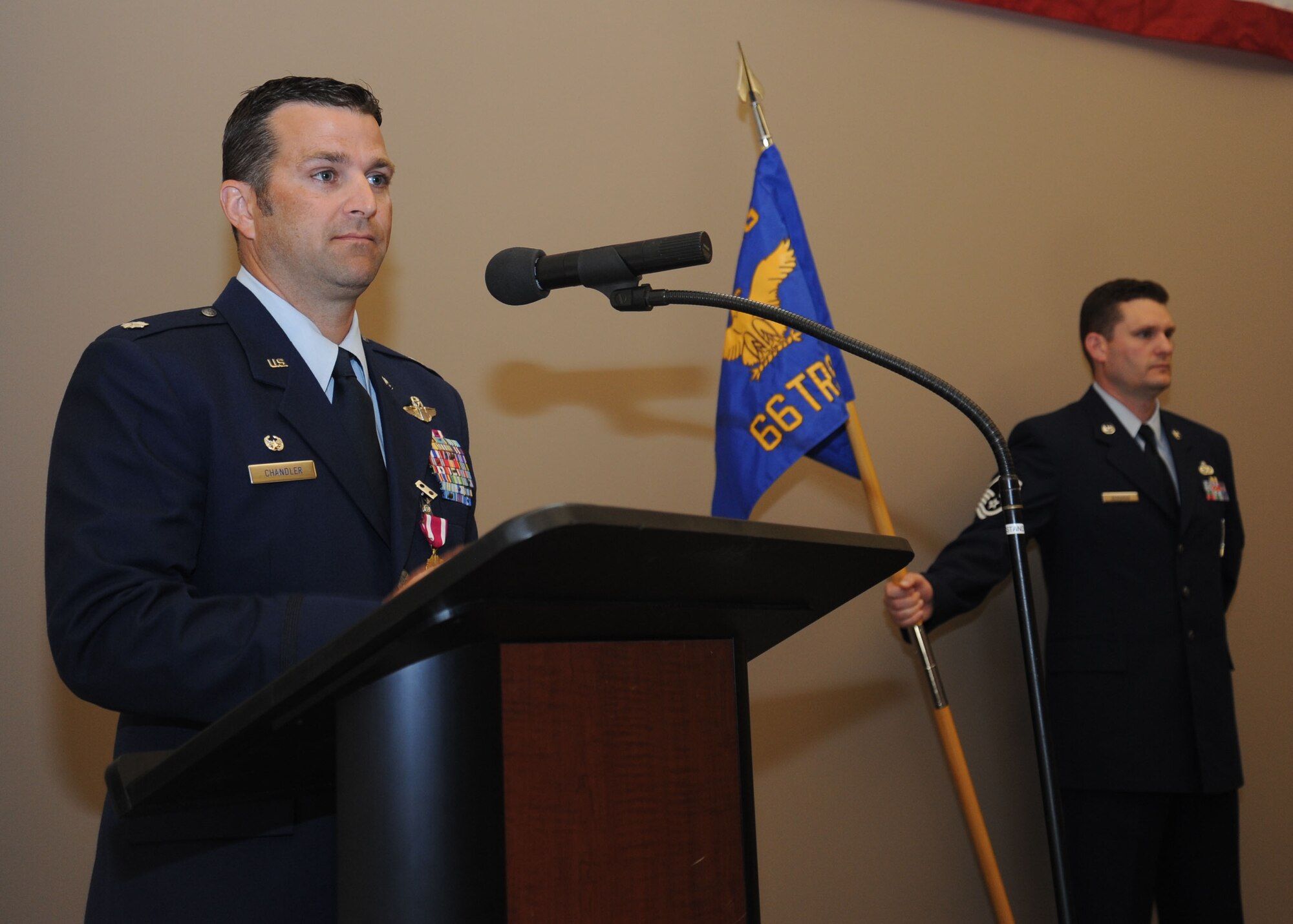 Lt. Col. Jason Chandler, former 66th Training Squadron commander, thanks his Airmen, friends, coworkers and family for their dedication to the mission and teamwork during the 66th TRS change of command ceremony June 30, 2015, at Fairchild Air Force Base, Wash. Chandler has deployed in support of Operations Joint Guard and Iraqi Freedom, and is a command pilot with more than 3,700 flight hours. (U.S. Air Force photo/Senior Airman Sam Fogleman)