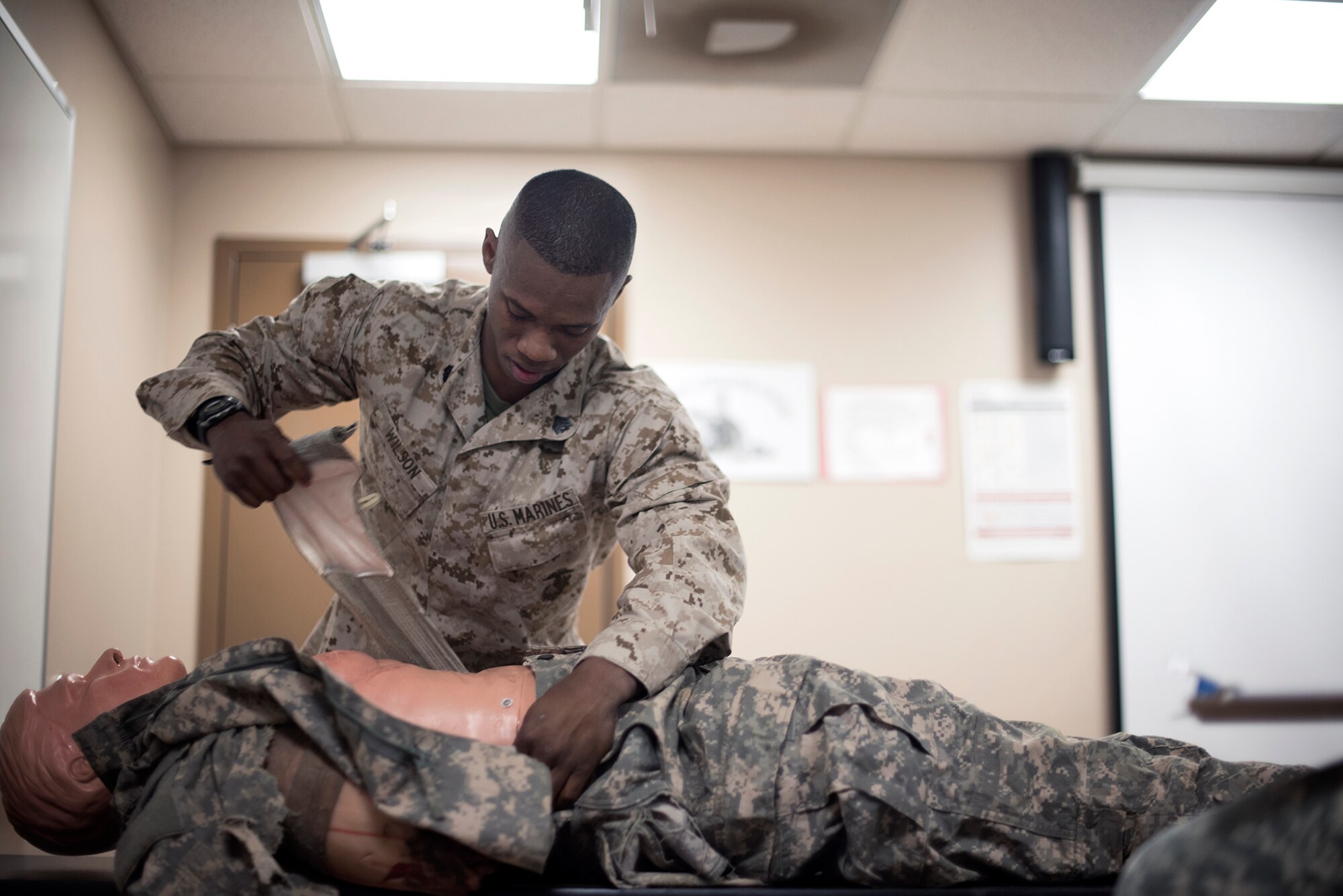 U.S. Marine Corps Sgt. David Wilson, Marine Aircraft Group 49, performs first aid on a mannequin during the Joint Base Service Member of the Year Competition May 14, 2015 at Joint Base McGuire-Dix-Lakehurst N.J. This was the first annual competition and featured eight competitors, two each from the U.S. Army, Marines Corps, Navy and Air Force. (U.S. Air Force photo by Senior Airman Tara Williamson)