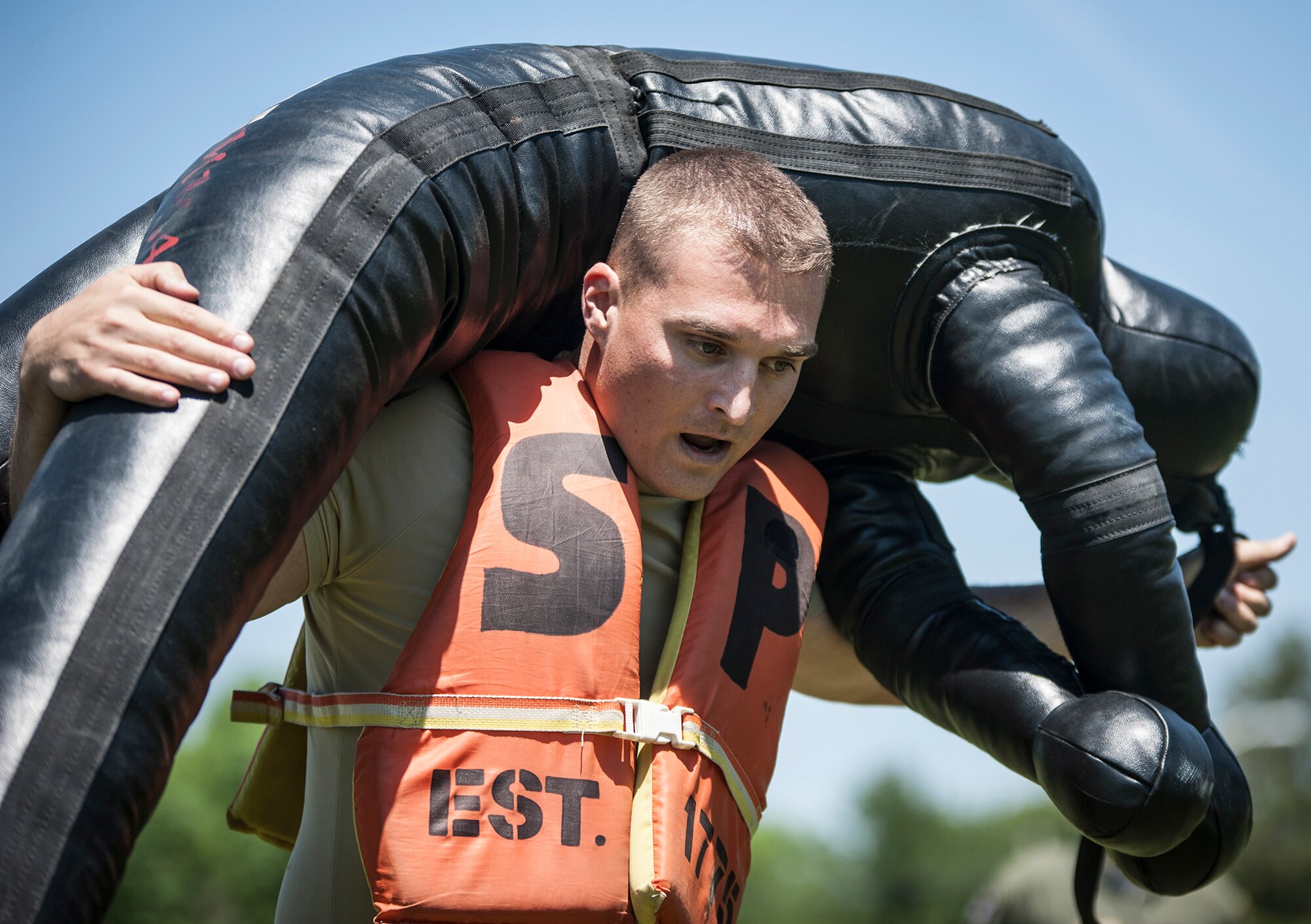 U.S. Air Force Master Sgt. Tyler Seeholzer, 421st Combat Training Squadron, carries a dummy weighing more than 100 pounds during the obstacle course portion of the Joint Base Service Member of the Year Competition May 14, 2015 at Joint Base McGuire-Dix-Lakehurst N.J. This was the first annual competition and featured seven events including a marksmanship qualification, first aid, a 100-point written examination, board appearance, urban orienteering, multi-service physical fitness test and an obstacle course. (U.S. Air Force photo by Senior Airman Scott Saldukas)