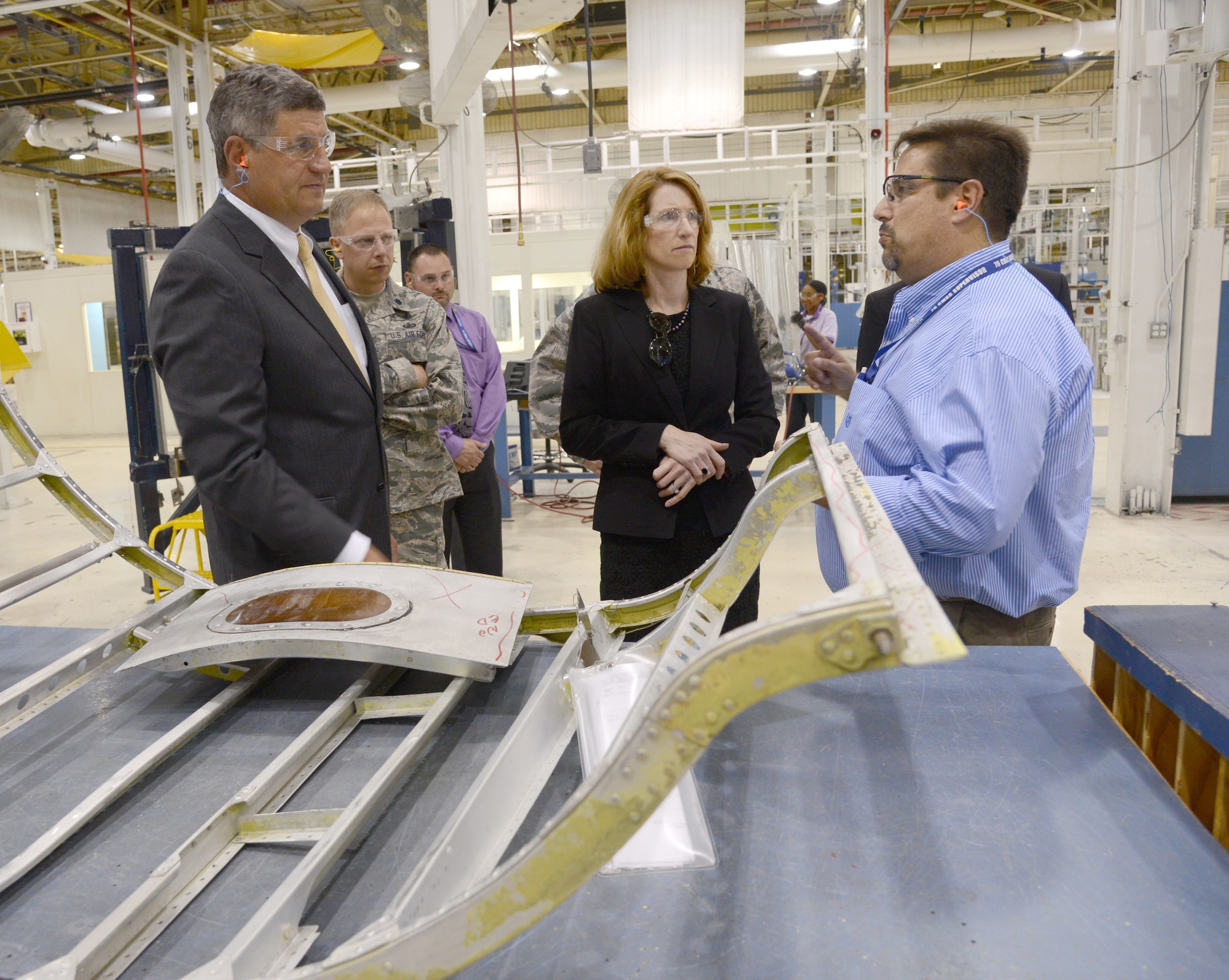 David Deal, with the 551st Commodities Maintenance Squadron, briefs the Honorable William LaPlante, Assistant Secretary of the Air Force (Acquisitions) (far left), and The Honorable Lisa Disbrow, the Acting Under Secretary of the Air Force and the Assistant Secretary of the Air Force for Financial Management and Comptroller (center), on how modular flow has increased cost-effective readiness in the B-52 Wrap Cowls shop.  The two senior leaders visited several Oklahoma Air Logistics Complex work centers as part of the visit to the AFSC here on Monday. U.S. Air Force photo by Kelly White.