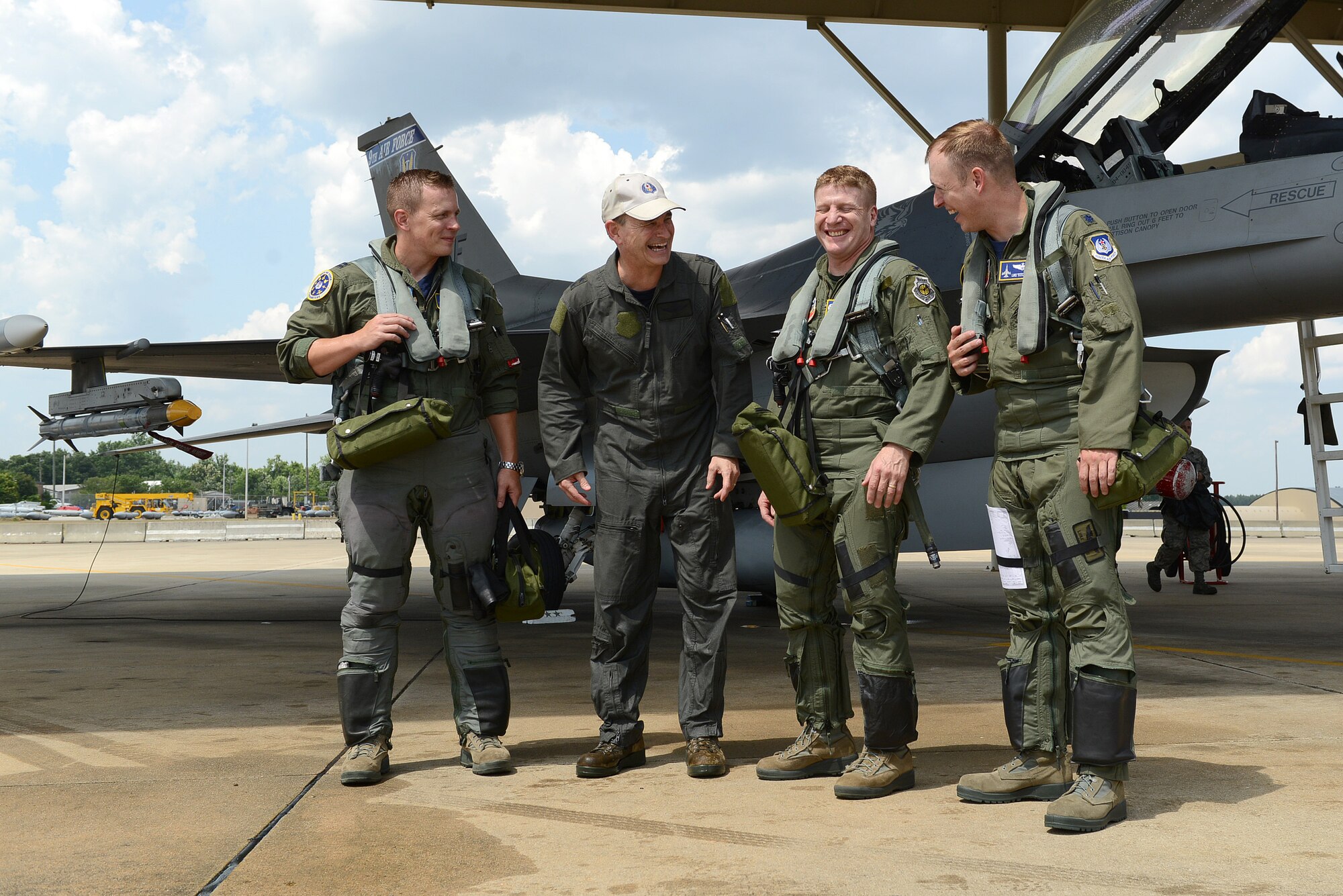 U.S. Air Force Maj. Gen. H. D. Polumbo Jr., Ninth Air Force commander, jokes with the pilots who accompanied him on his final flight at Shaw Air Force Base, S.C., June 26, 2015. The final flight, also known as the fini-flight, is a ceremonial flight for pilots to bid the departing Airman farewell. (U.S. Air Force photo by Senior Airman Diana M. Cossaboom/Released)