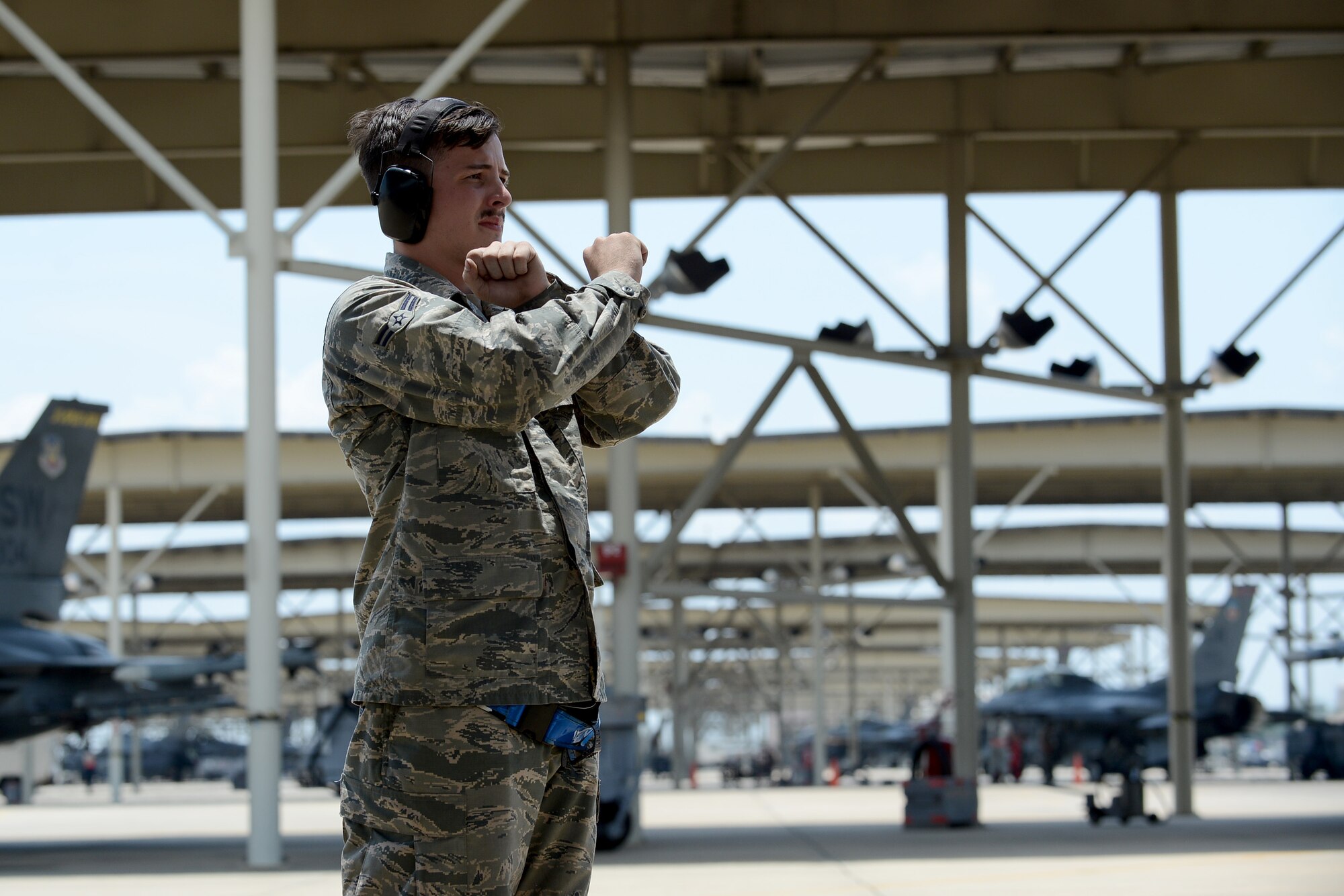 U.S. Air Force Airman 1st Class Jamie Ince, 55th Aircraft Maintenance Unit assistant dedicated crew chief, signals Maj. Gen. H. D. Polumbo Jr., Ninth Air Force commander, to prepare for taxi during Polumbo’s final flight at Shaw Air Force Base, S.C., June 26, 2015. The tactical aircraft maintainers ensure the safety of Shaw pilots before taking off for training exercises and missions. (U.S. Air Force photo by Senior Airman Diana M. Cossaboom/Released)