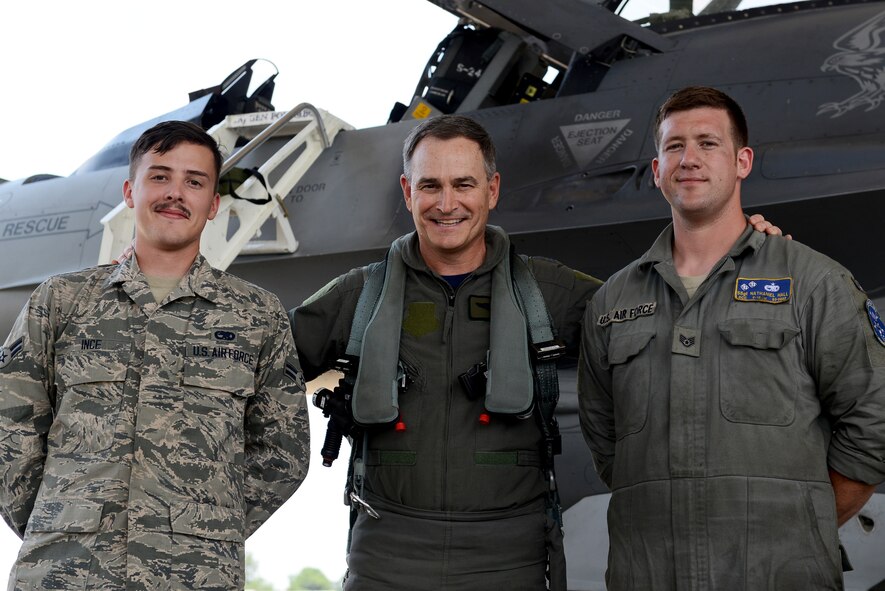 U.S. Air Force Maj. Gen. H. D. Polumbo Jr., Ninth Air Force commander, Staff Sgt. Nathaniel Hall, 55th Aircraft Maintenance Unit dedicated crew chief, and Airman 1st Class Jamie Ince, 55th Aircraft Maintenance Unit assistant dedicated crew chief, gather for a photo before Polumbo’s final flight at Shaw Air Force Base, S.C., June 26, 2015. Polumbo showed appreciation for the tactical aircraft maintainers assigned to his F-16CM Fighting Falcon by presenting them his commander’s coin for excellence after his flight. (U.S. Air Force photo by Senior Airman Diana M. Cossaboom/Released)