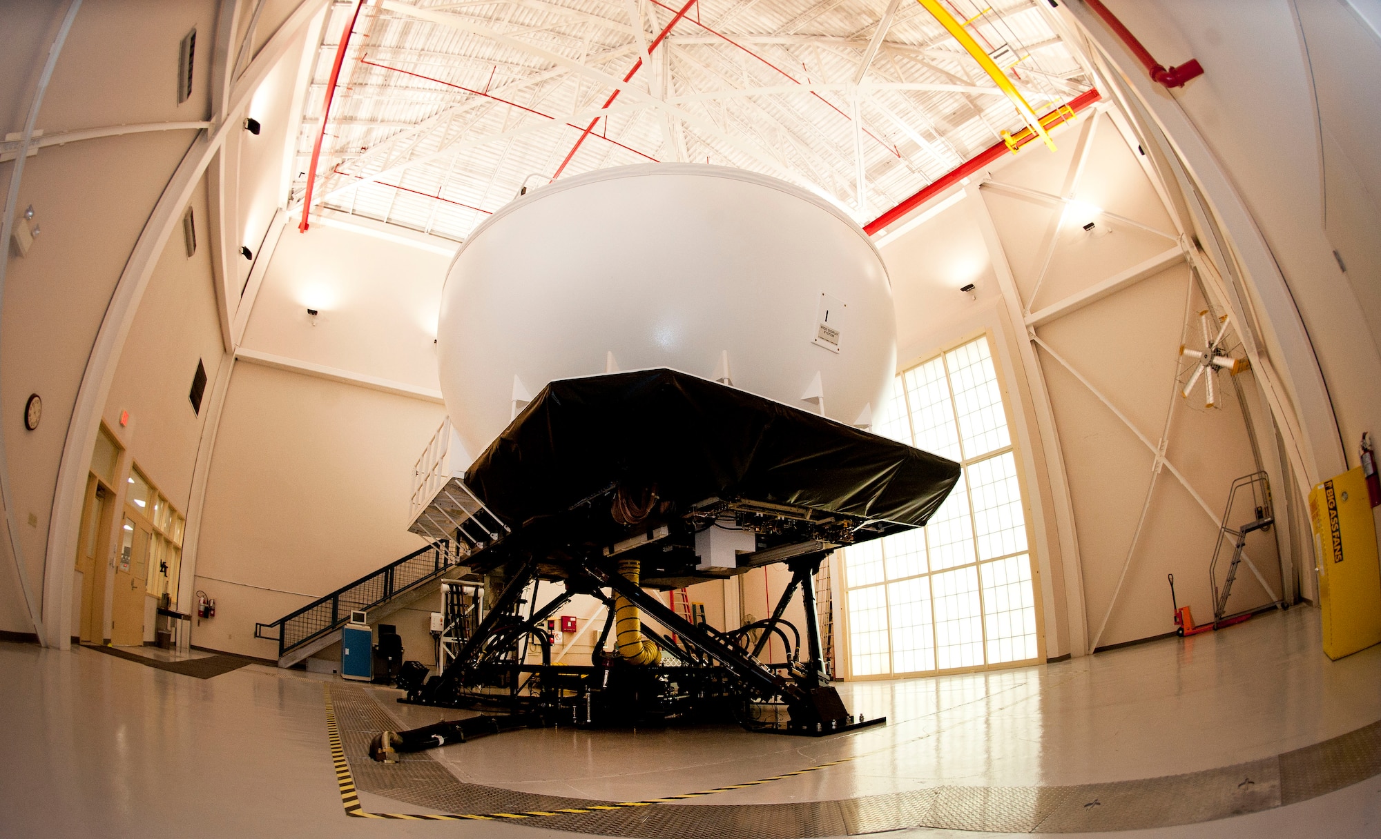 The flight simulation and training system is newly upgraded with the latest visual system at MacDill Air Force Base, Fla. The upgrades include a projector replacement, scene processors, out-the-window channels, adding 21 moving models and installing 35 new databases to improve the visual system of the trainer. (U.S. Air Force photo by Senior Airman Jenay Randolph/Released)