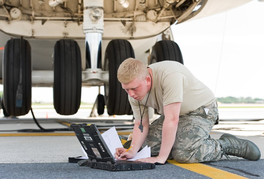 Airman 1st Class Christopher Kent, 436th Aircraft Maintenance Squadron electric and environmental technician, checks technical data on a maintenance laptop June 25, 2015, on Dover Air Force Base, Del. Kent used the laptop to accurately document in the aircraft maintenance forms the removal and replacement actions of faulty components that control the right aft main landing gear. (U.S. Air Force photo/Roland Balik)