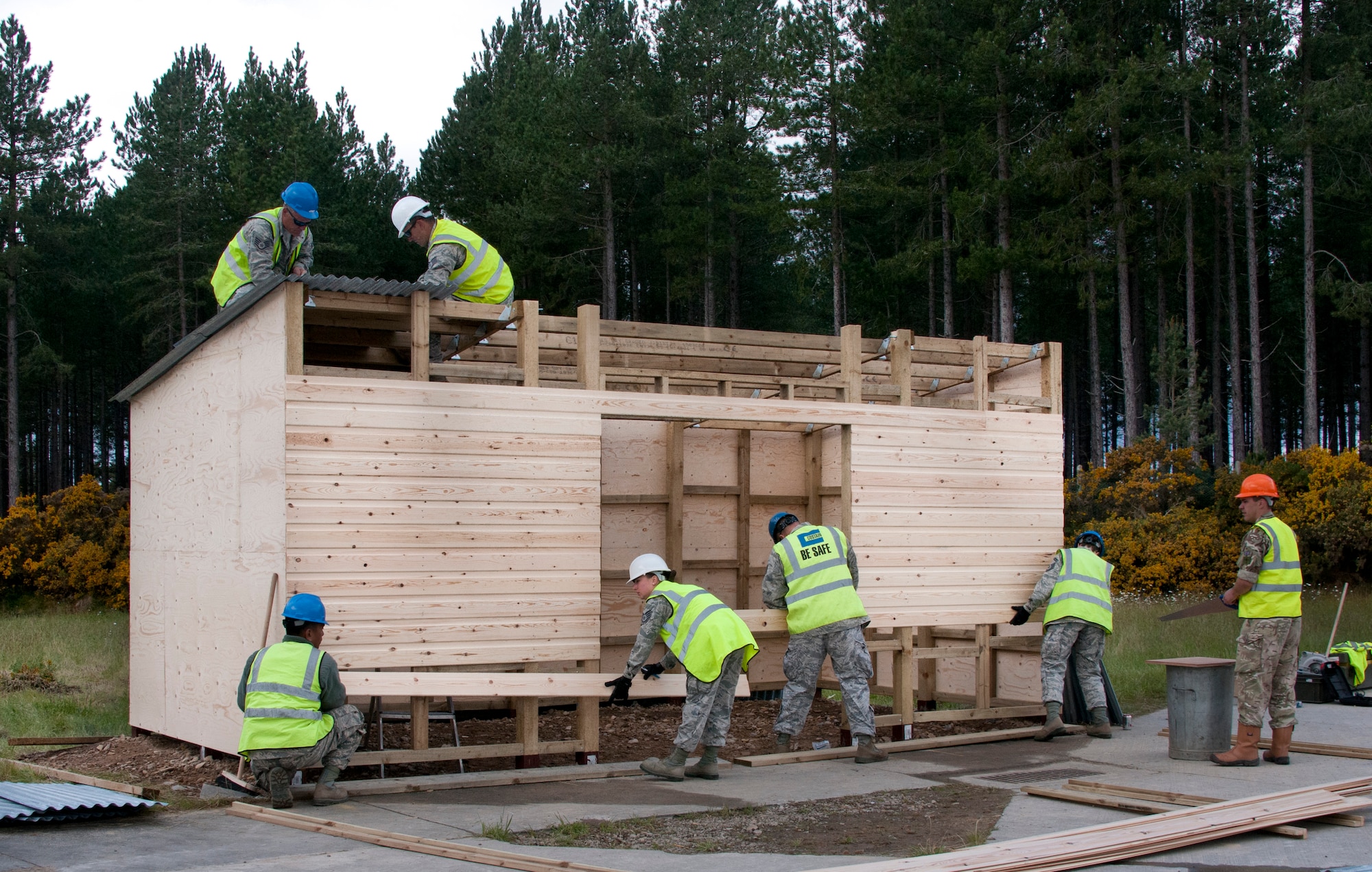 U.S. Air Force Airmen of the 128th Air Refueling Wing, Wisconsin, Civil Engineering Squadron work to complete a troop shelter June 17, 2015, at Kinloss Barracks in Morayshire, Scotland, United Kingdom. The troop shelter is set to be used by the British Army for Kinloss Barracks’ air support training. The building of a troop shelter was a task assigned to the airmen in support of Exercise Flying Rose. The 128th Air Refueling Wing Civil Engineering Squadron Airmen were participating in Exercise Flying Rose, an exchange exercise between the U.S. Air National Guard and British Army where forces deploy to one another’s countries and work to complete construction-related tasks. (U.S. Air National Guard photo by Airman 1st Class Morgan R. Lipinski/Released)
