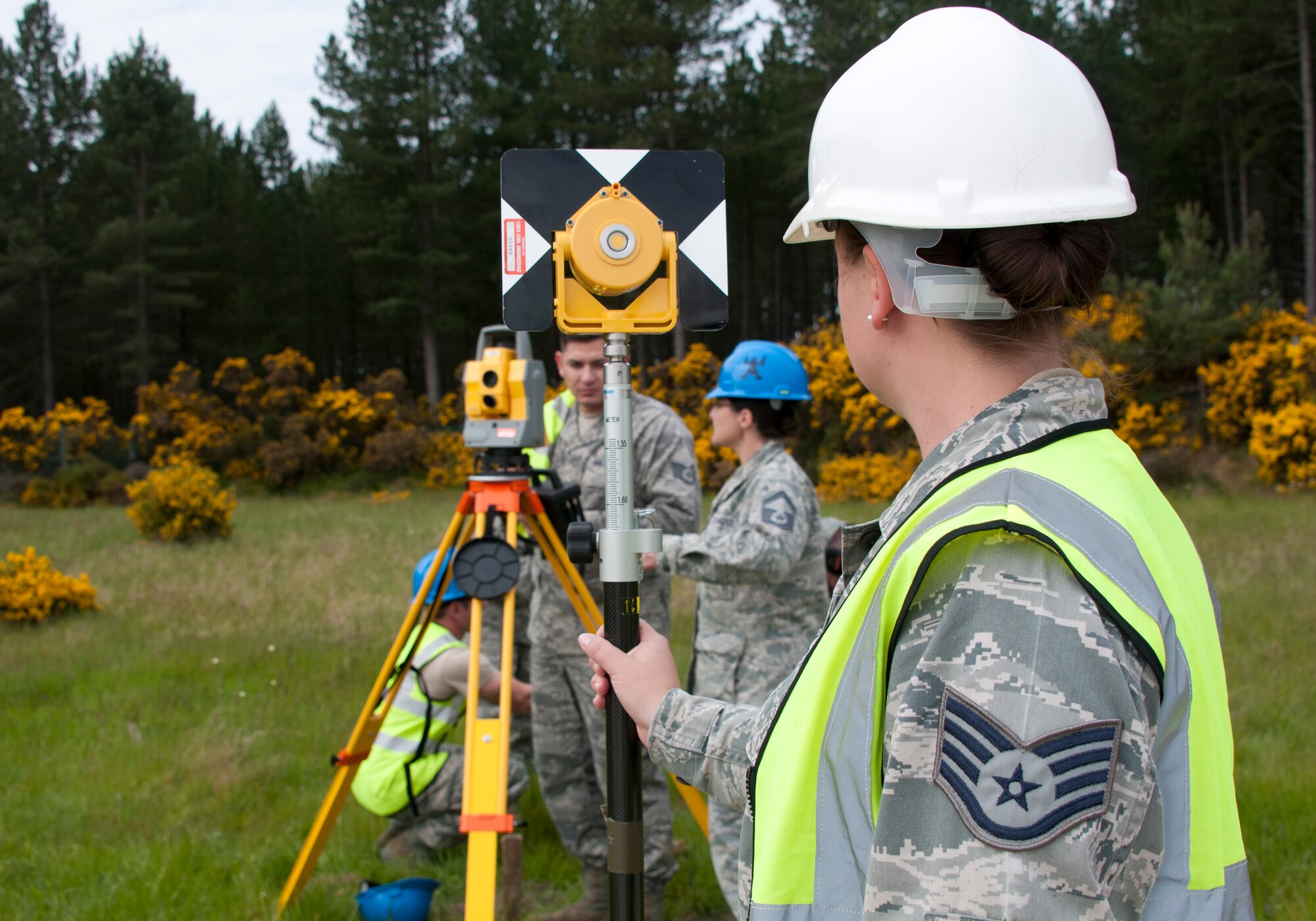 U.S. Air Force Staff Sgt. Melissa Mussa, an HVAC specialist with the Civil Engineering Squadron of the 128th Air Refueling Wing, holds a Trimble SPS730 Robotic Total Station June 10, 2015, at Kinloss Barracks in Morayshire, Scotland, United Kingdom, in support of Exercise Flying Rose. The Trimble SPS730 Robotic Total Station is a surveying instrument used to measure the angles, elevations, and distances involved in a construction site. The Airmen were preparing this site for the construction of a troop shelter, set to be used during Kinloss Barracks’ training missions.  (U.S. Air National Guard photo by Airman 1st Class Morgan R. Lipinski/Released)