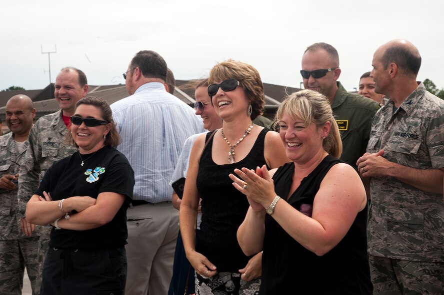 Family and friends celebrate with U.S Air Force Col. Chad Franks, 23d Wing commander, after his fini-flight June 26, 2015, at Moody Air Force Base, Ga. The "fini-flight" is a time-honored military aviation tradition marking the last flight of a pilot's or commander's time with a unit. (U.S. Air Force photo by Andrea Jenkins/Released)

