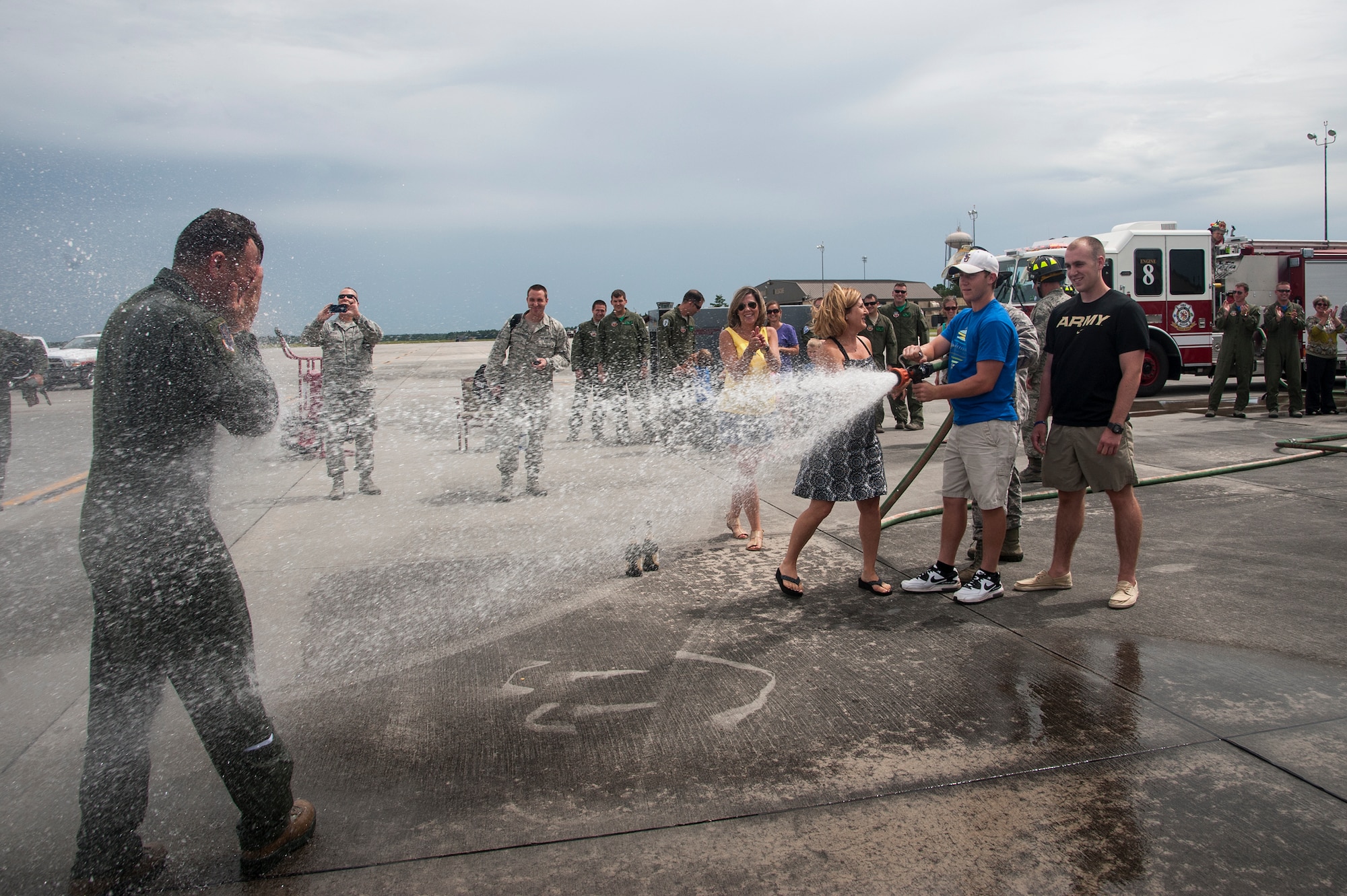 Kim Franks, wife of U.S. Air Force Col. Chad Franks, 23d Wing commander, and their two sons hose him off after his fini-flight June 26, 2015, at Moody Air Force Base, Ga. This was Franks’ last flight at Moody before he relinquishes command of the 23d Wing. (U.S. Air Force photo by Andrea Jenkins/Released)

