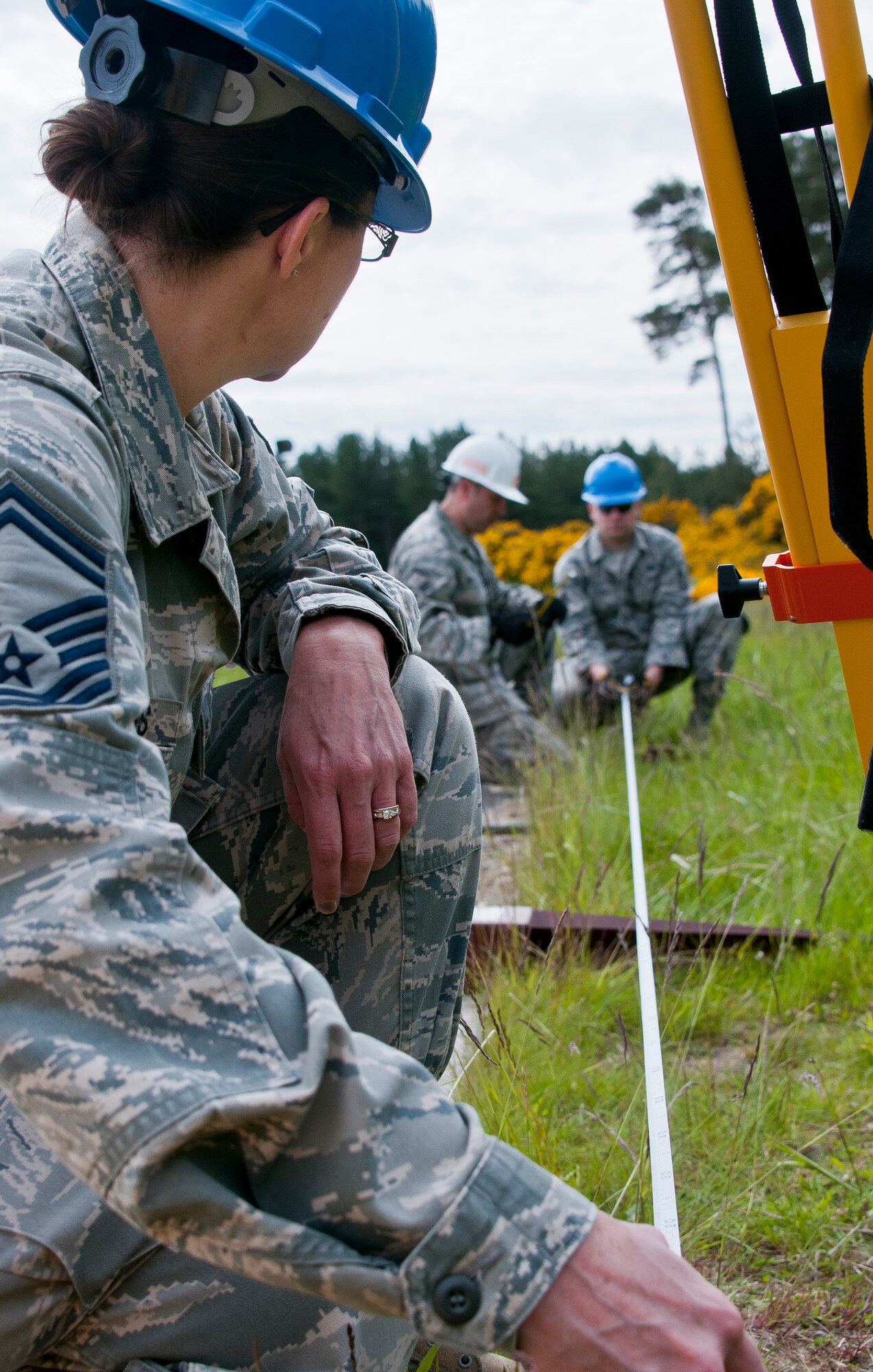 U.S. Air Force Senior Master Sgt. Cheryl Morris, a Civil Engineering Squadron superintendent with the 128th Air Refueling Wing, uses a tape measure to determine the distance between foundation posts June 10, 2015, at Kinloss Barracks in Morayshire, Scotland, United Kingdom, in support of Exercise Flying Rose. The posts were part of the foundation of a troop shelter built by the Airmen, set to be used during Kinloss Barracks’ training missions. The 128 ARW CE Airmen were building the troop shelter in support of Exercise Flying Rose, an exchange exercise between the U.S. Air National Guard and British Army, where forces deploy to one another’s countries and work to complete construction-related tasks. (U.S. Air National Guard photo by Airman 1st Class Morgan R. Lipinski/Released)