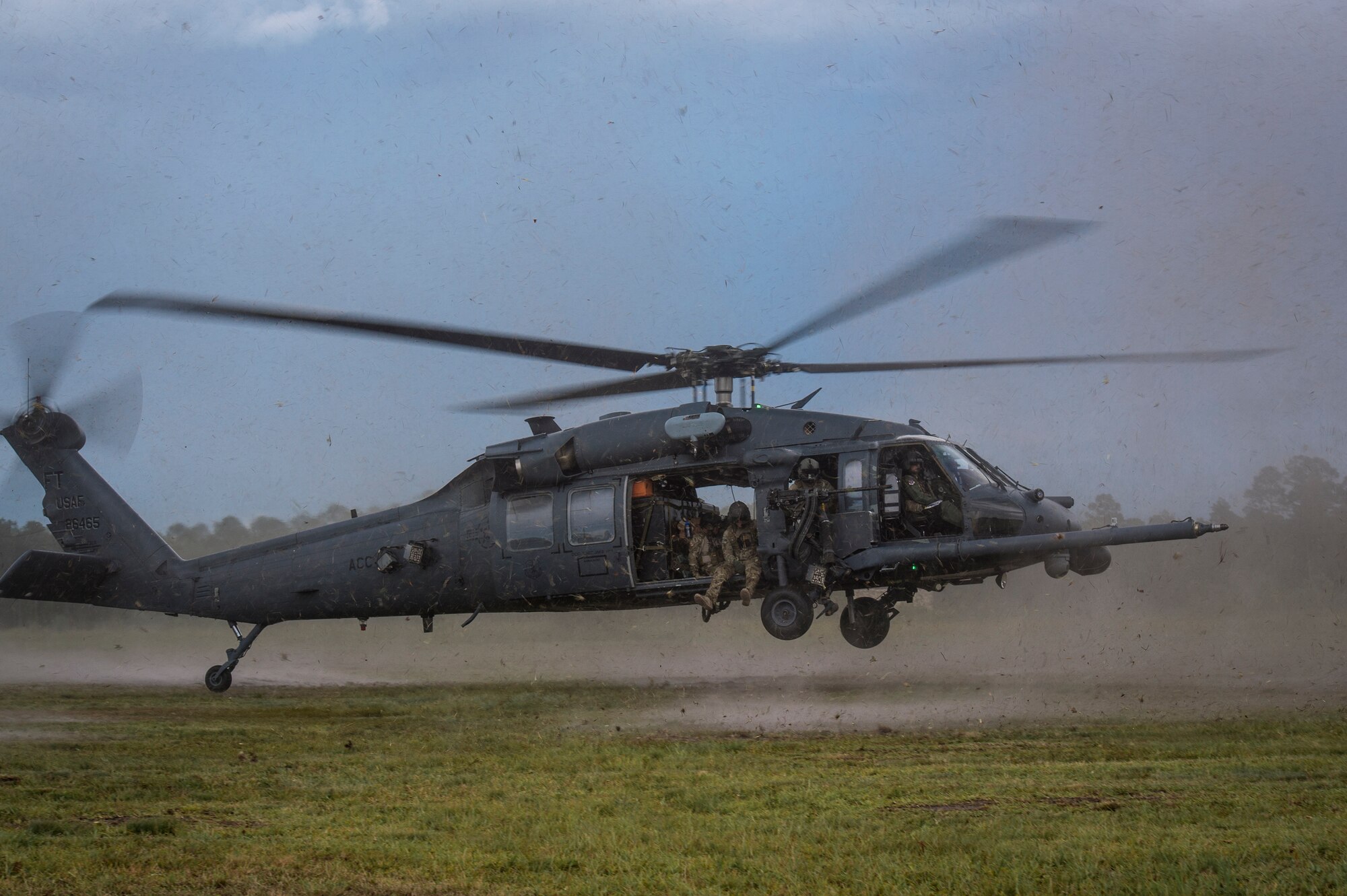 An HH-60G Pave Hawk flown by U.S. Air Force Col. Chad Franks, 23d Wing commander, lands on Grand Bay Bombing and Gunnery Range June 26, 2015, at Moody Air Force Base, Ga. Franks final flight included rescue tactics, flight maneuvers and aerial gunnery. (U.S. Air Force photo by Senior Airman Ryan Callaghan/Released)

