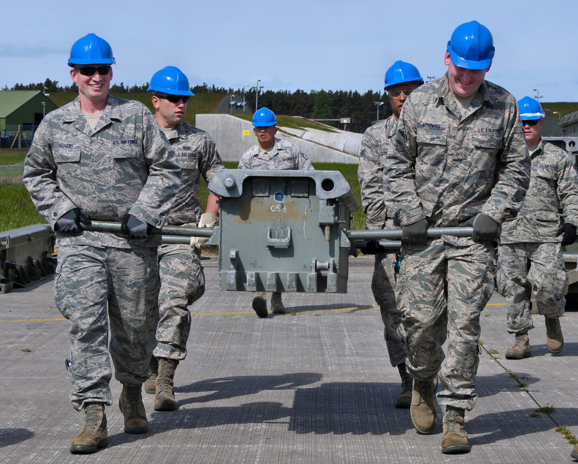 U.S. Air Force Airmen with the Civil Engineering Squadron of the 128th Air Refueling Wing, Wisconsin Air National Guard, work together to move training equipment June 9, 2015, at Kinloss Barracks in Morayshire, Scotland, United Kingdom, in support of Exercise Flying Rose. Exercise Flying Rose is an exchange exercise between the U.S. Air National Guard and British Army, where forces deploy to one another’s countries and work to complete construction-related tasks. (U.S. Air National Guard photo by Airman 1st Class Morgan R. Lipinski/Released)