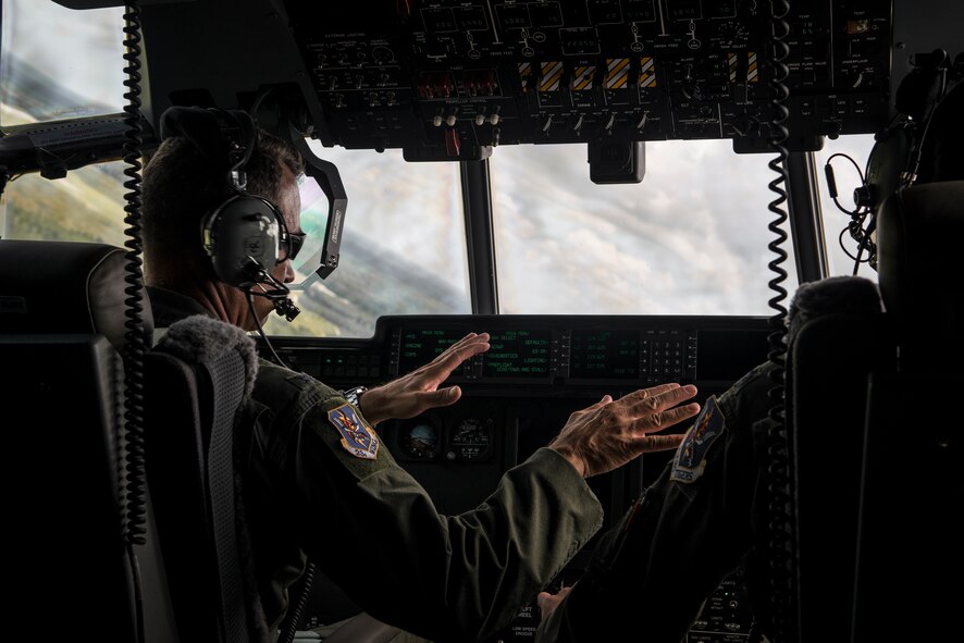 U.S. Air Force Col. Chad Franks, 23d Wing commander, gives control of an HC-130J Combat King II to Lt. Col. Sean Hosey, 71st Rescue Squadron commander, during his fini-flight June 26, 2015, over Moody Air Force Base, Ga. The final or “fini” flight is a long-standing Air Force tradition that traces its roots back to the Vietnam War when pilots would commemorate their final combat mission. (U.S. Air Force photo by Senior Airman Ryan Callaghan/Released)
