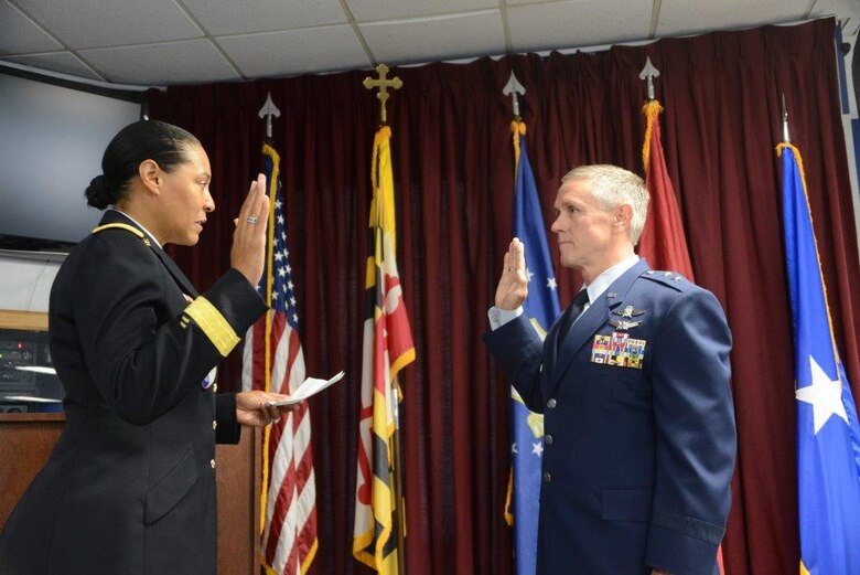 Maj. Gen. Linda Singh (MD), adjutant general for Maryland, administers the oath of office for Maj. Gen. Paul C. Maas, Jr., the assistant to the commander, Air Force Space Command.