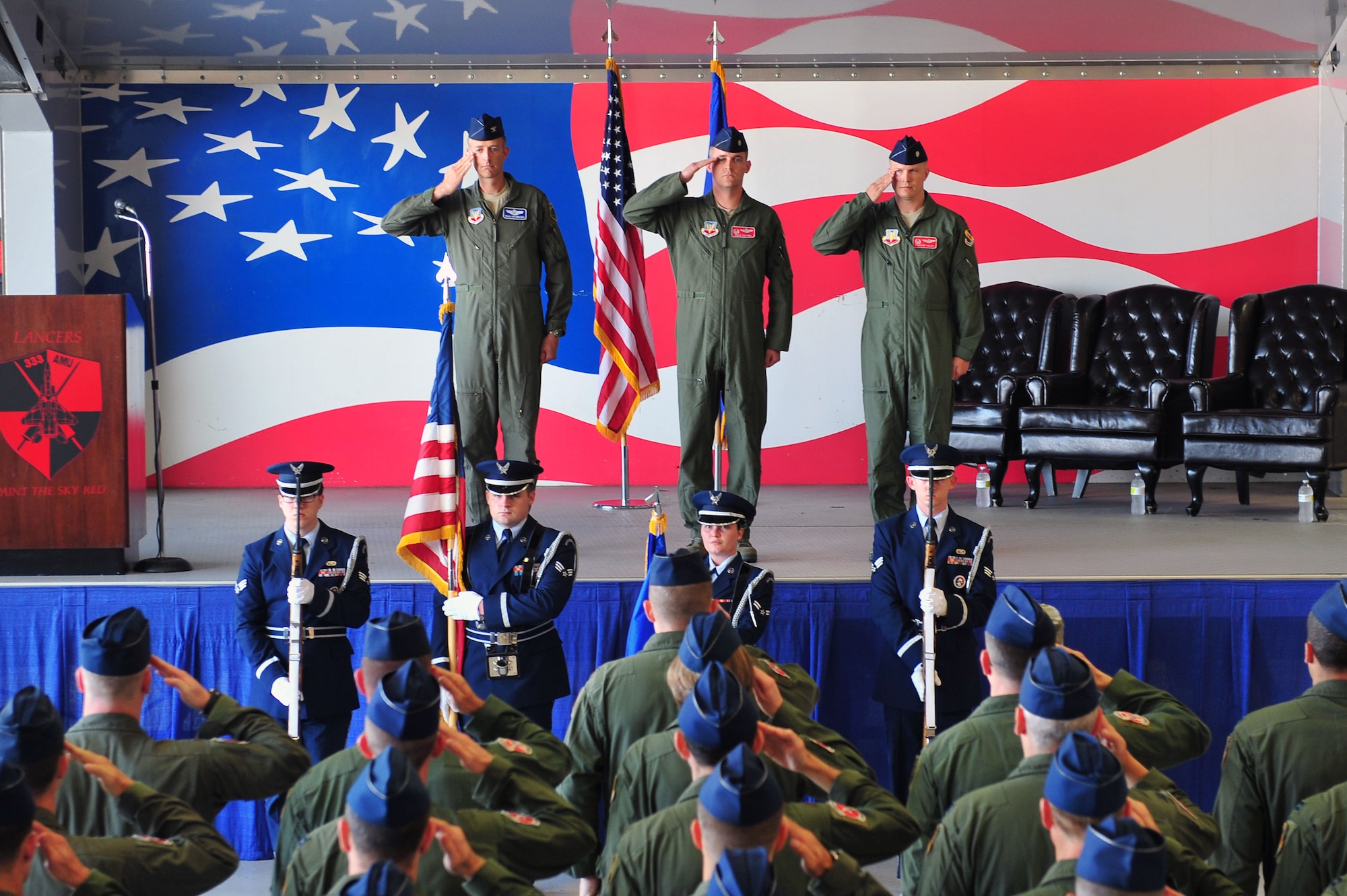 Airmen salute as members of the base honor guard present the colors during the 333rd Fighter Squadron change of command ceremony, June 30, 2015, at Seymour Johnson Air Force Base, North Carolina. The 333rd FS was first activated on December 8, 1957, and have since housed the F-100 Super Sabre, F-105 Thunderchief, and the A-10A Thunderbolt II in addition to the F-15E Strike Eagle. (U.S. Air Force photo/Senior Airman John Nieves Camacho)