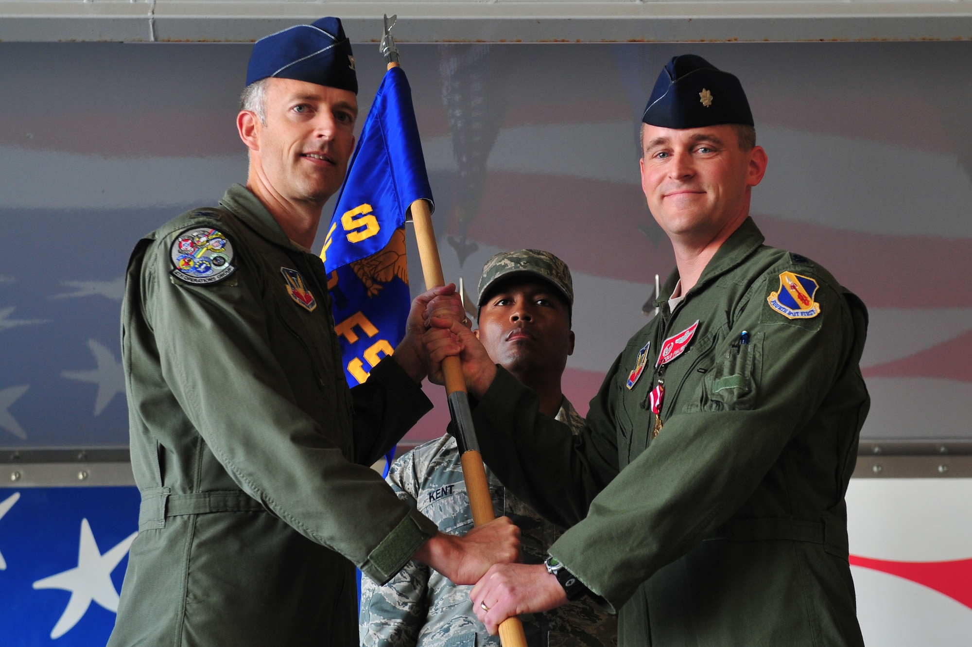Lt. Col. Thomas Palmer, right, outgoing 333rd Fighter Squadron commander, relinquishes the guidon to Col. Brian Afflerbaugh, 4th Operations Group commander, during the 333rd FS change of command ceremony, June 30, 2015, at Seymour Johnson Air Force Base, North Carolina. Palmer has served as the 333rd FS commander since May 17, 2013. (U.S. Air Force photo/Senior Airman John Nieves Camacho)