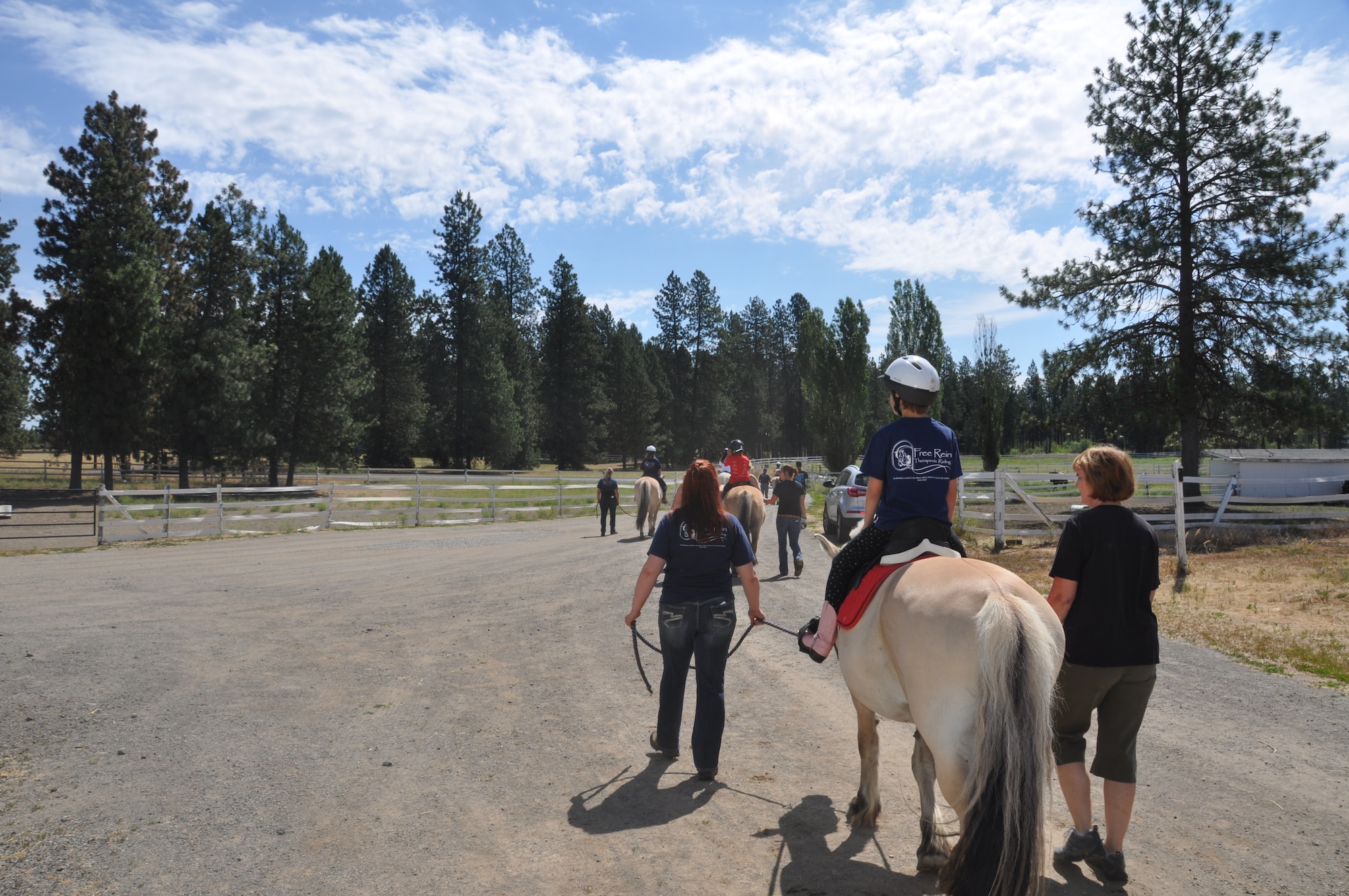 Team Fairchild children enjoy a trail ride during a horseback riding day camp June 22, 2015, in Spokane, Wash. The Exceptional Family Member Program coordinated the five-day camp where children learned how to interact with and ride horses. Horseback riding helps build muscle, improves joint movement and enhances balance and coordination. (U.S. Air Force photo/2nd Lt. Shelley Gregory)
