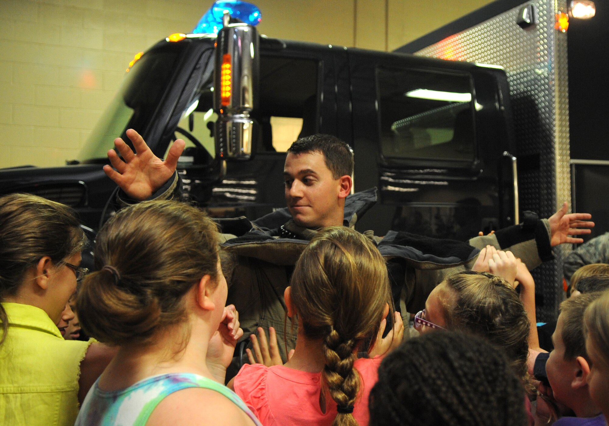 Science and Technology Academies Reinforcing Basic Aviation and Space Exploration students test the strength of a bomb suit worn by Airman 1st Class Nathanael Banden, 4th Civil Engineer Squadron explosive ordnance disposal technician, June 25, 2015, at Seymour Johnson Air Force Base, North Carolina. STARBASE is open to children in North Carolina during the summer before their fifth grade year. (U.S. Air Force photo/Senior Airman Ashley J. Thum)