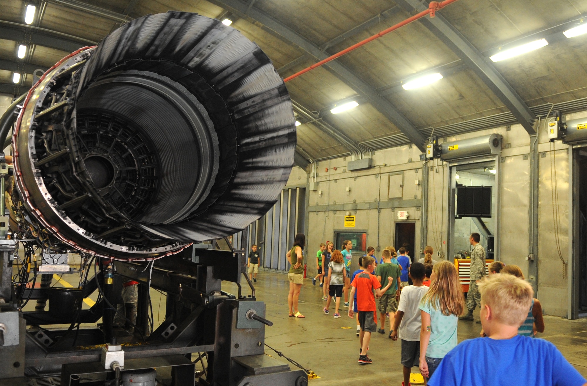 Science and Technology Academies Reinforcing Basic Aviation and Space Exploration students file past an F-15E Strike Eagle engine after their tour of the 4th Component Maintenance Squadron’s “Hush House,” June 23, 2015, at Seymour Johnson Air Force Base, North Carolina. The students also visited the squadron’s facility for disassembling, repairing, and reassembling aircraft engine modules. (U.S. Air Force photo/Senior Airman Ashley J. Thum)