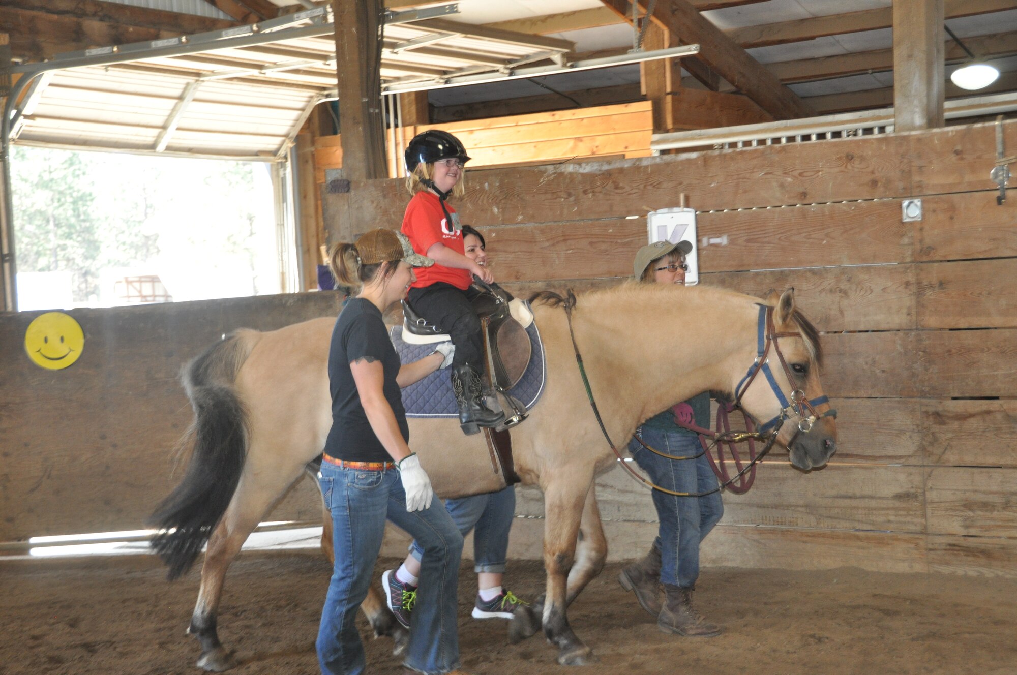 Marlee McDaniel, daughter of 92nd Air Refueling Wing commander Col. Brian McDaniel, rides around an arena during a five-day horseback riding day camp June 22, 2015, in Spokane, Wash. The Exceptional Family Member Program coordinated the summer camp where children learned how to interact with and ride horses. (U.S. Air Force photo/2nd Lt. Shelley Gregory)