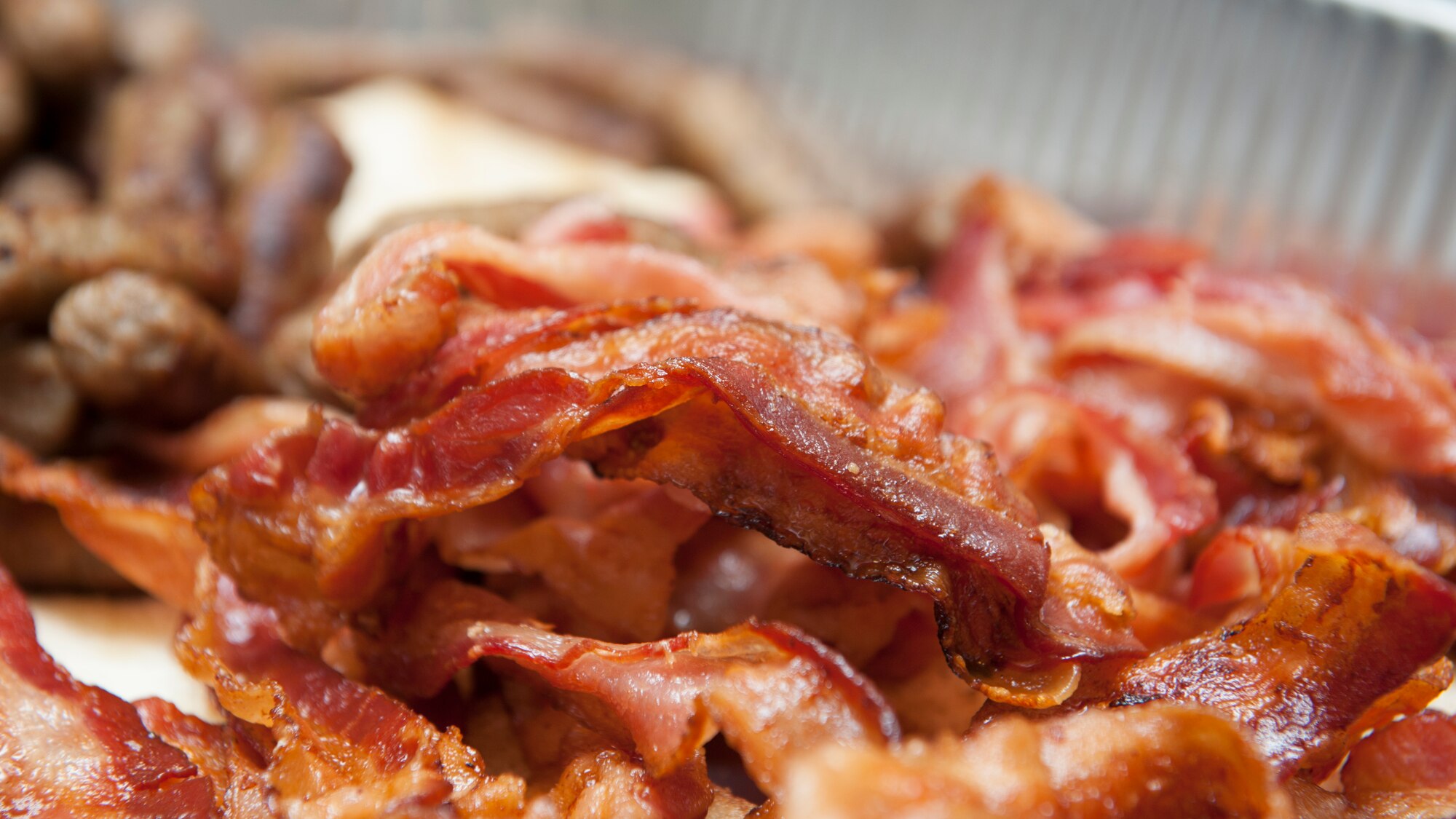 Bacon sits in a tray during a dorm dinner June 25, 2015, at Dover Air Force Base, Del. Breakfast foods, including bacon, sausage, pancakes, muffins and eggs were served. (U.S. Air Force photo/Airman 1st Class Zachary Cacicia)