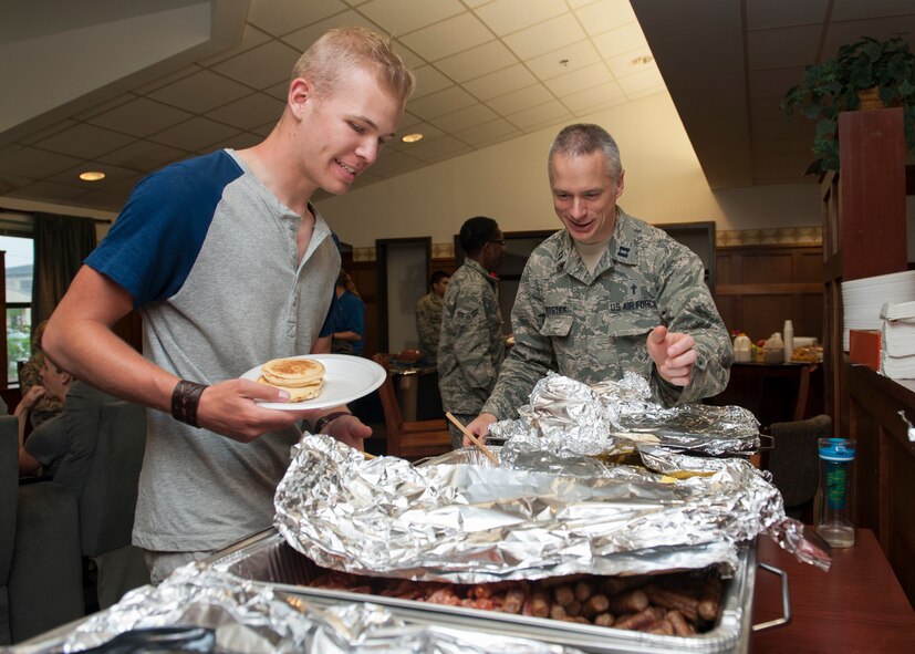 Chaplain (Capt.) Rory Pitstick, 436th Airlift Wing chaplain, and Airman 1st Class Clayton Sherrill, 436th Maintenance Squadron munitions systems, grab self-service breakfast during a dorm dinner June 25, 2015, at Dover Air Force Base, Del. The dorm dinner was sponsored by the Eagle’s Net Café and the base Chapel. (U.S. Air Force photo/Airman 1st Class Zachary Cacicia) 
