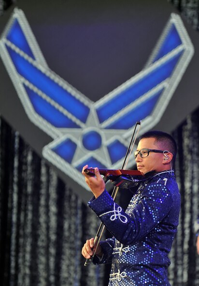 U.S. Air Force 1st Lt. Oliver Chang, a Developmental Engineer at Los Angeles Air Force Base, Calif., performs the National Anthem with his violin at the Tops in Blue concert June 27 at the Sumtur Amphitheater, Papillion, Neb.  The Tops in Blue band performs for a seven-month long tour spanning not only the United States but also overseas.  (U.S. Air Force photo by/Josh Plueger Released)  